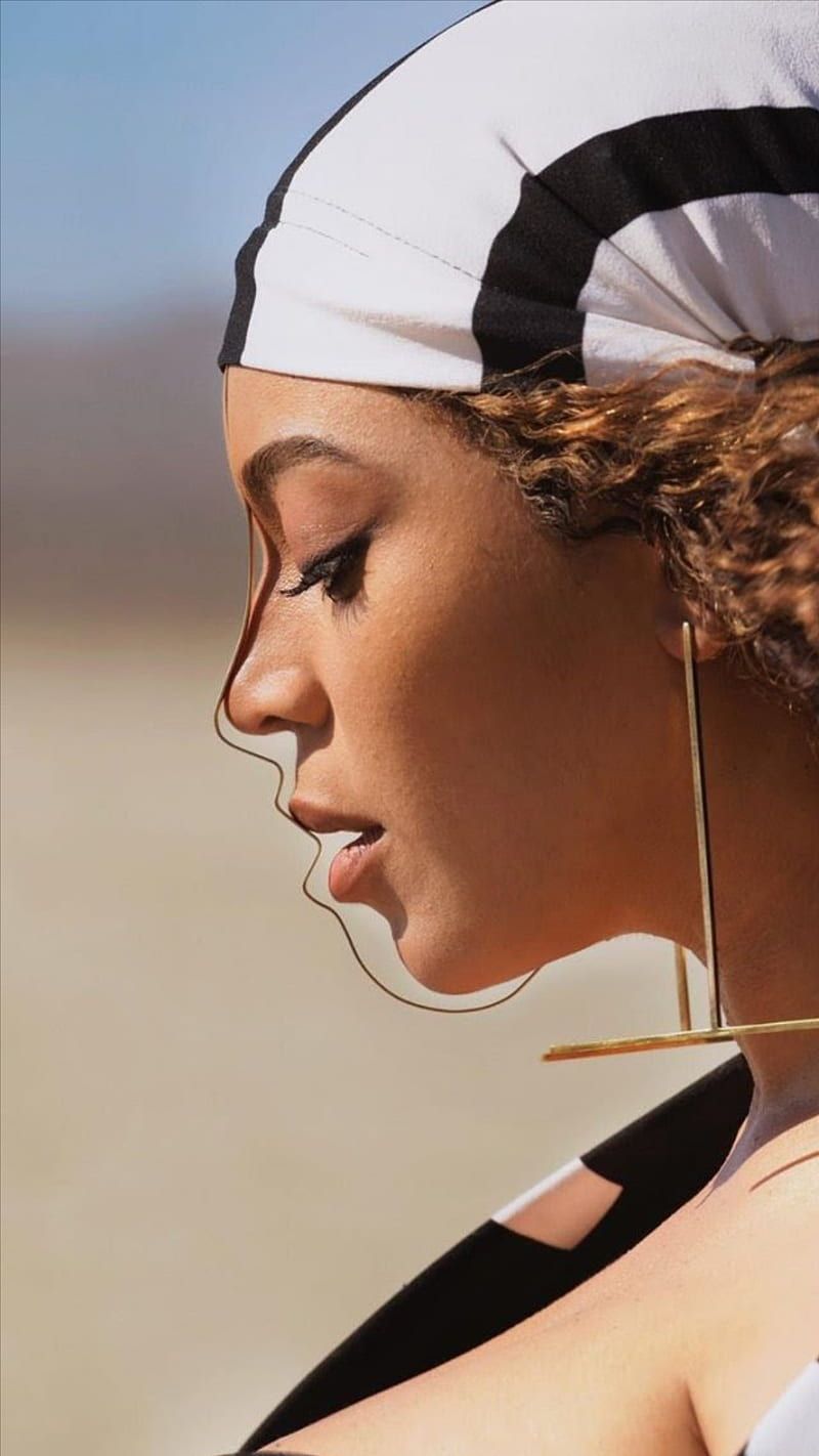 A woman with long hair and earrings - Beyonce