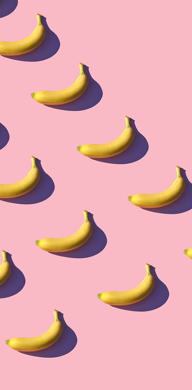 A pattern of bananas on a pink background. - Banana