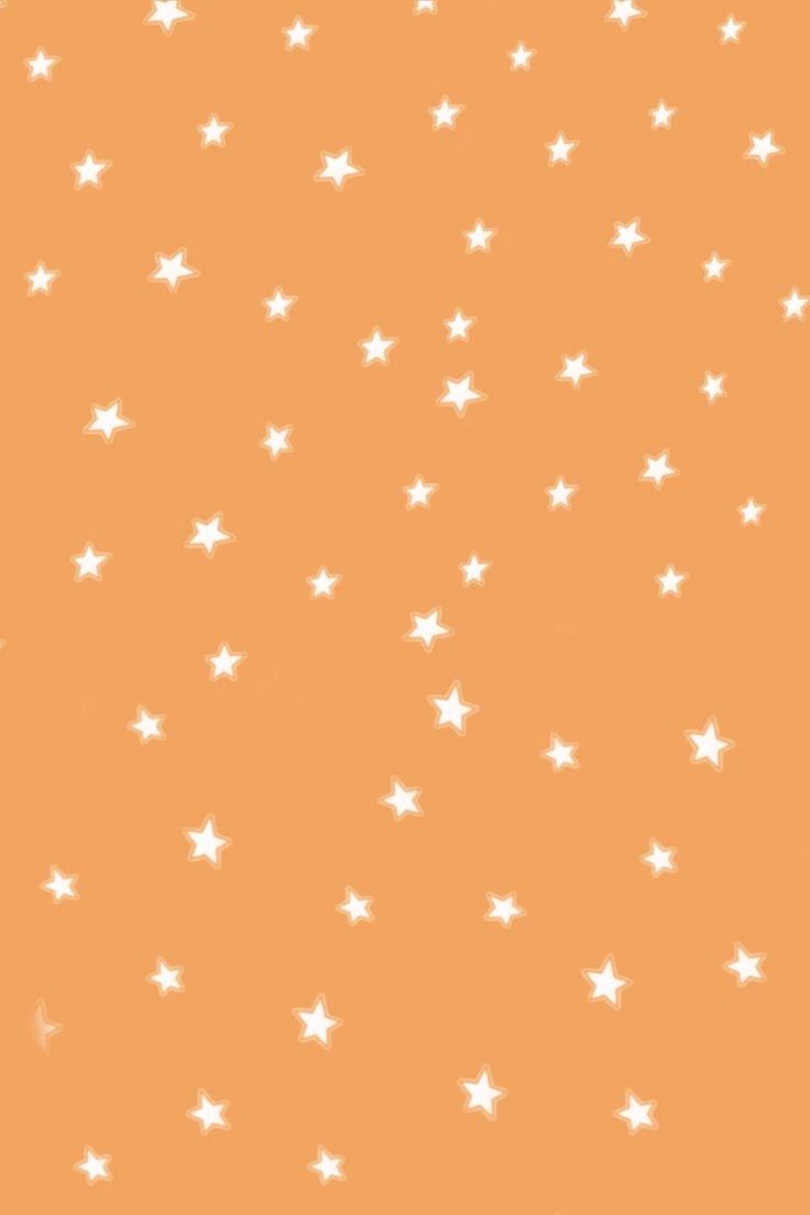A close up of an orange background with white stars - Pastel orange