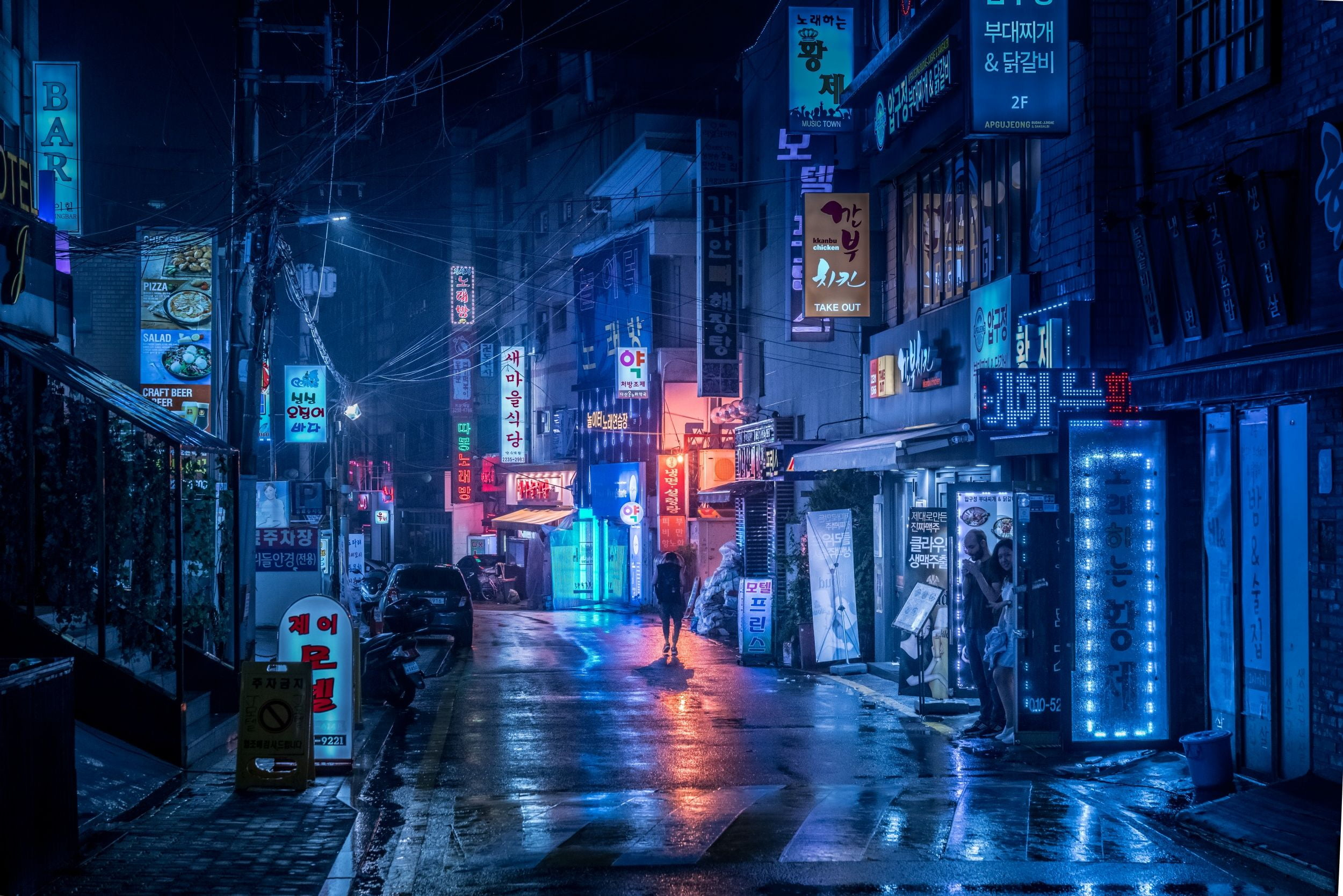 A man walks down a neon-lit street in Seoul, South Korea. - Anime city