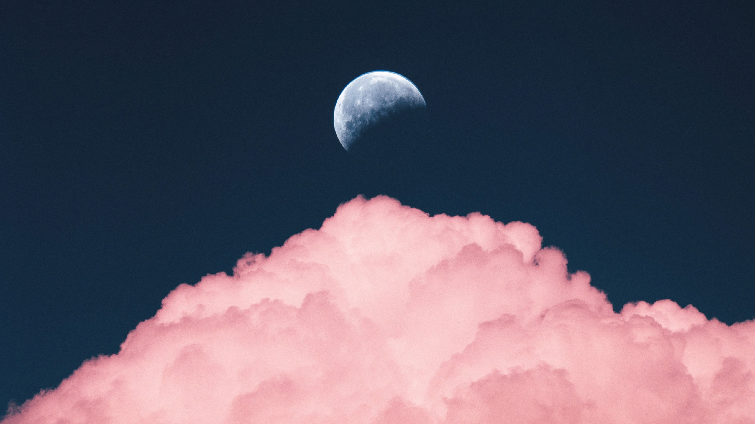 A pink cloud with a half moon in the sky - 2560x1440