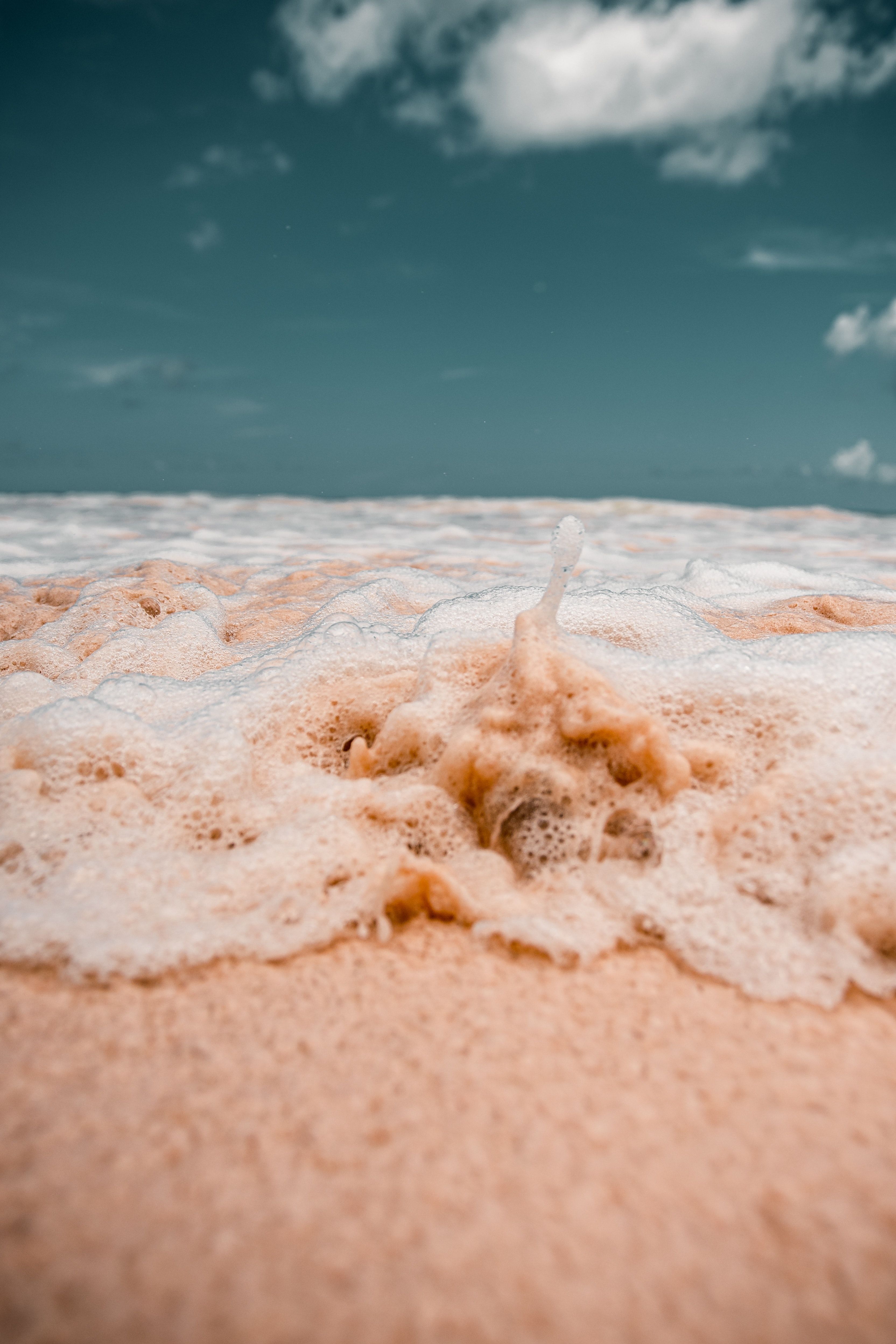 A wave is crashing on the beach - Beach, sand