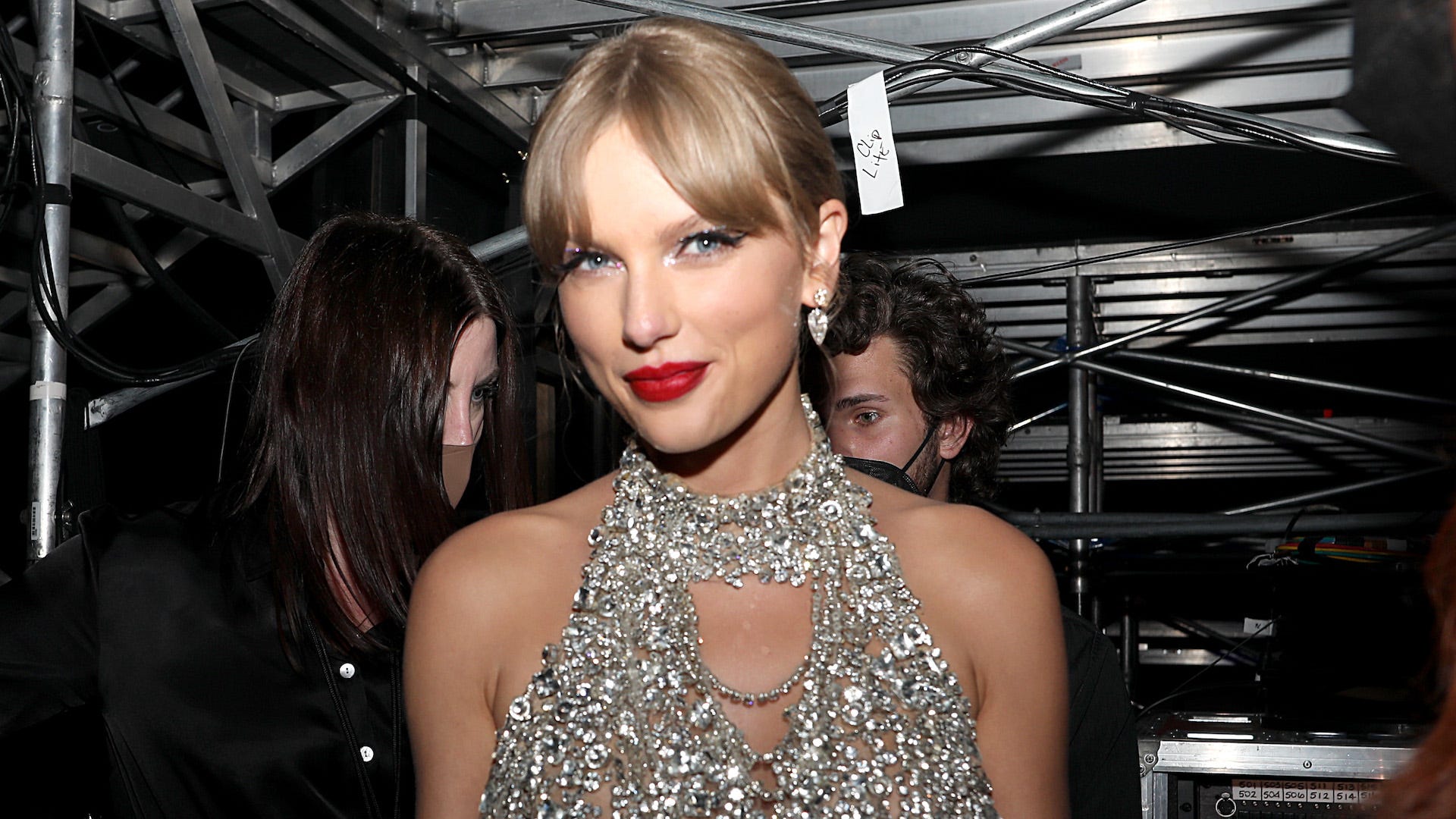 Taylor Swift wears a silver bejeweled dress and red lipstick in the Grammys press room - Taylor Swift