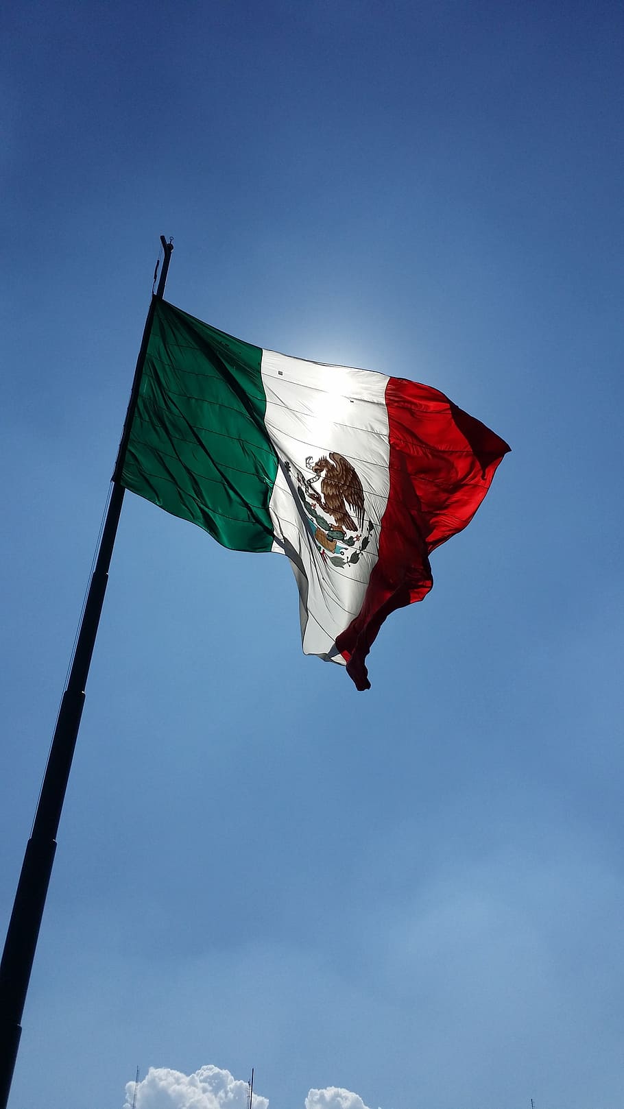 A flag of mexico flying in the sky - Mexico