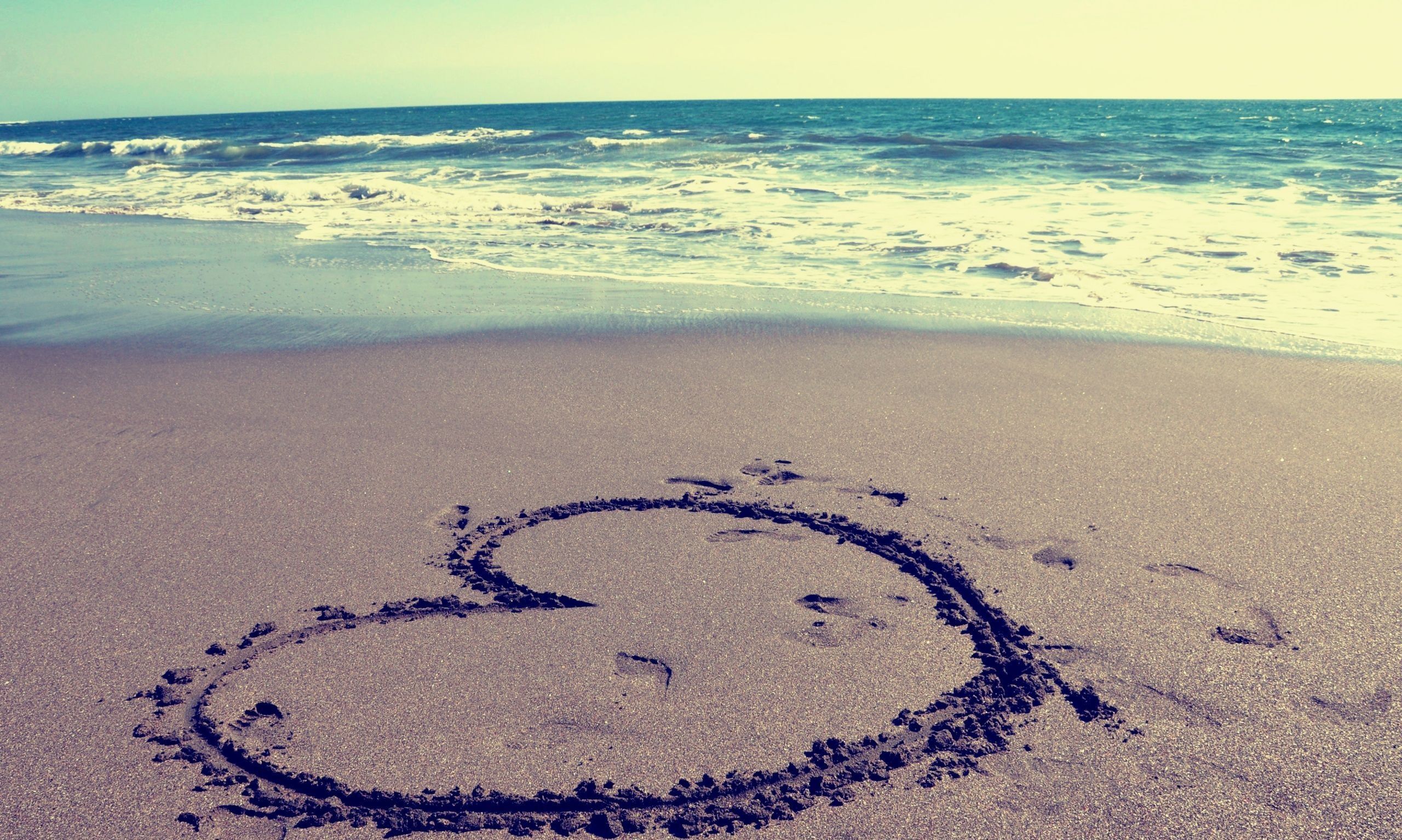 A heart drawn in the sand on a beach. - Beach