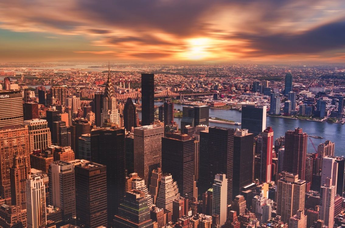 A sunset over a city with tall buildings - New York, cityscape