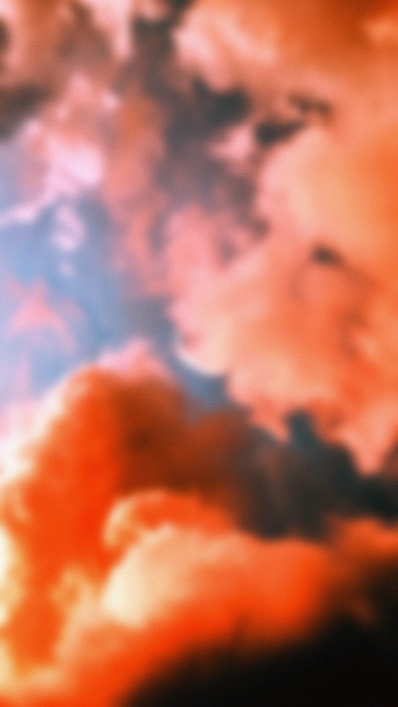 A photo of a cloud of orange smoke. - Blurry