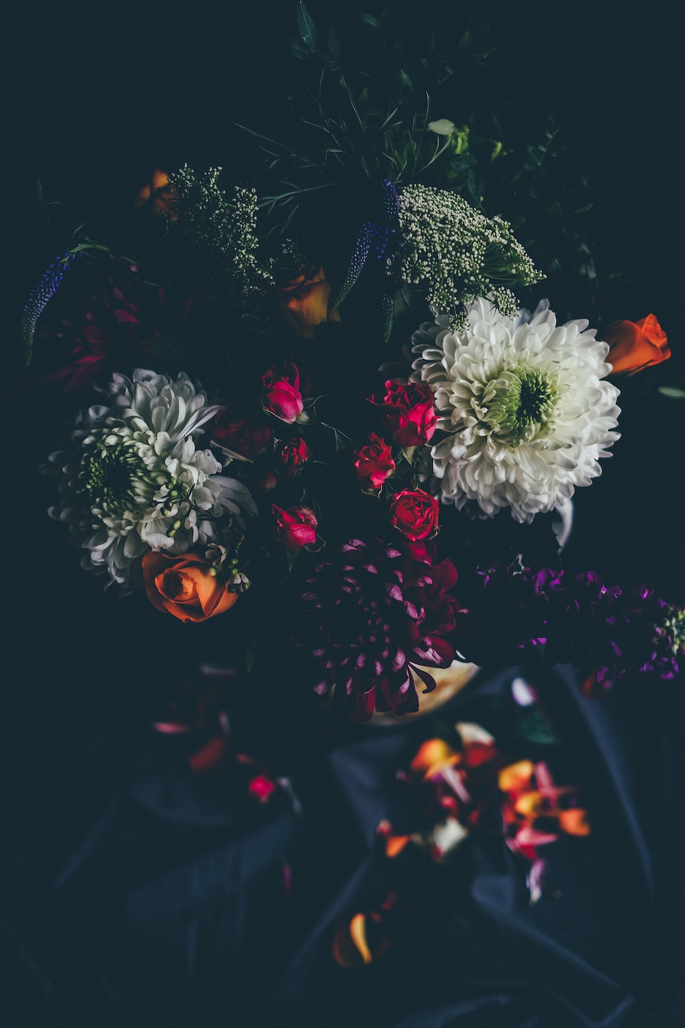 A vase of flowers on top black cloth - Blurry