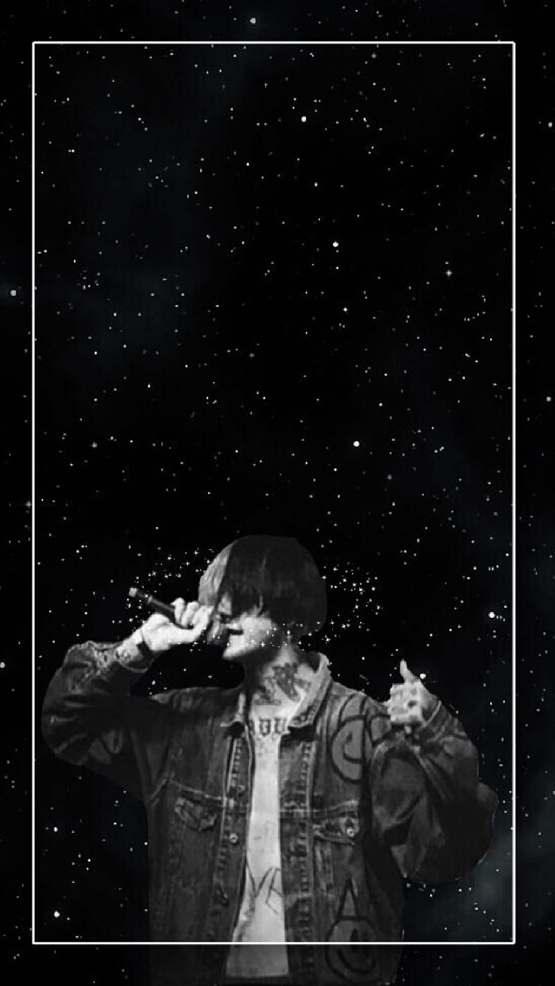 A man in black with stars behind him - Lil Peep
