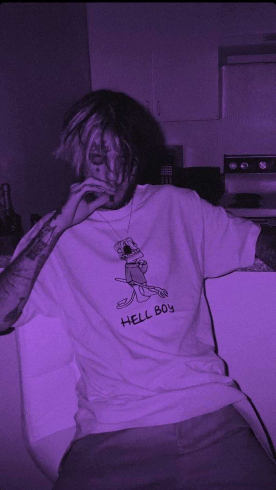 A man sitting in front of the kitchen counter - Lil Peep