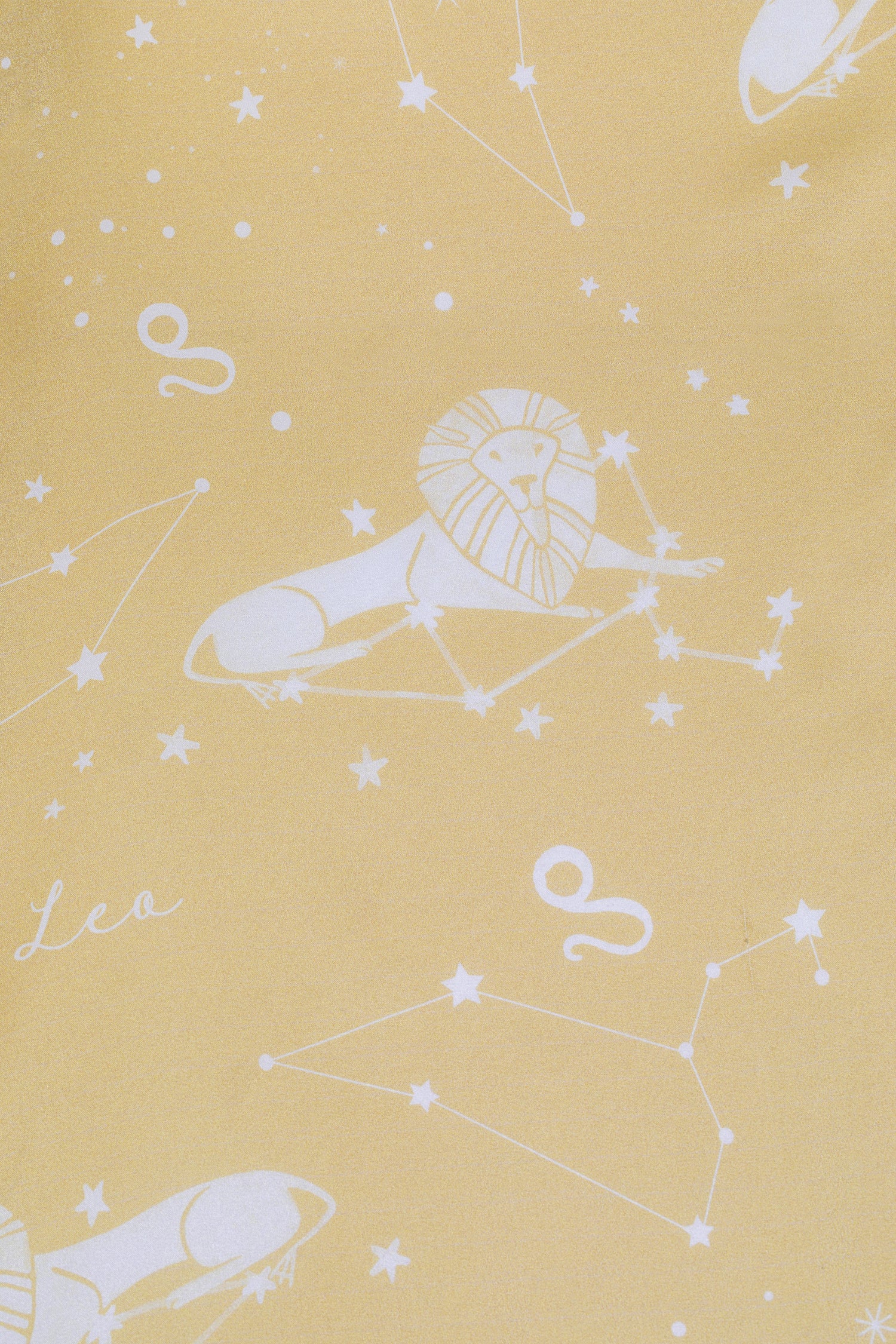 A yellow background with white stars and planets - Leo