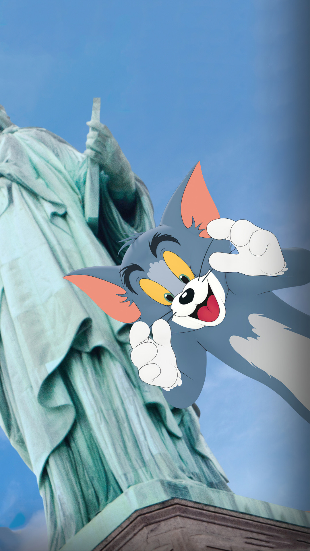 A cartoon cat is standing next to the statue of liberty - Tom and Jerry