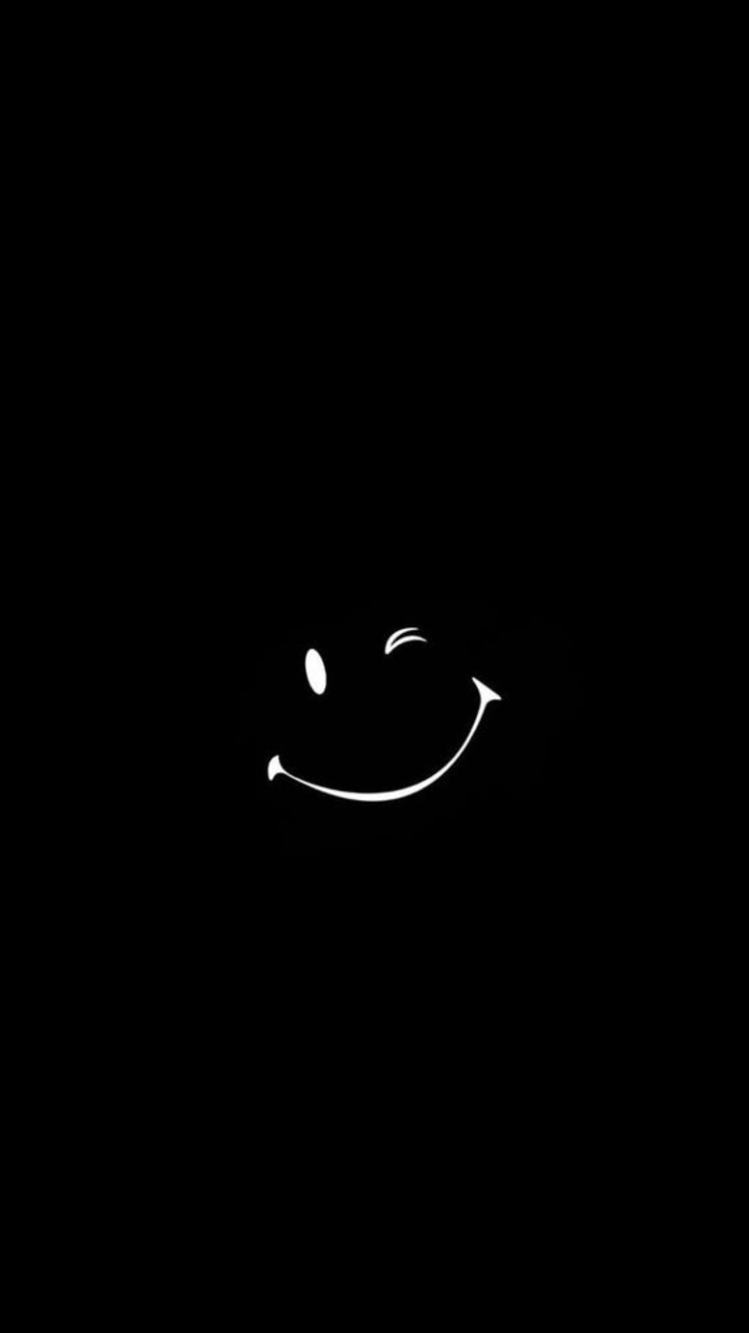 A black wall with white smiley face - Smile