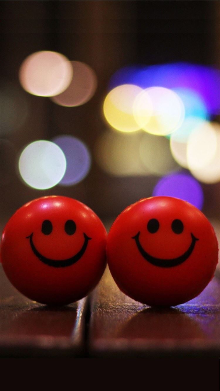 IPhone wallpaper with a bokeh background of two smiley balls - Smile
