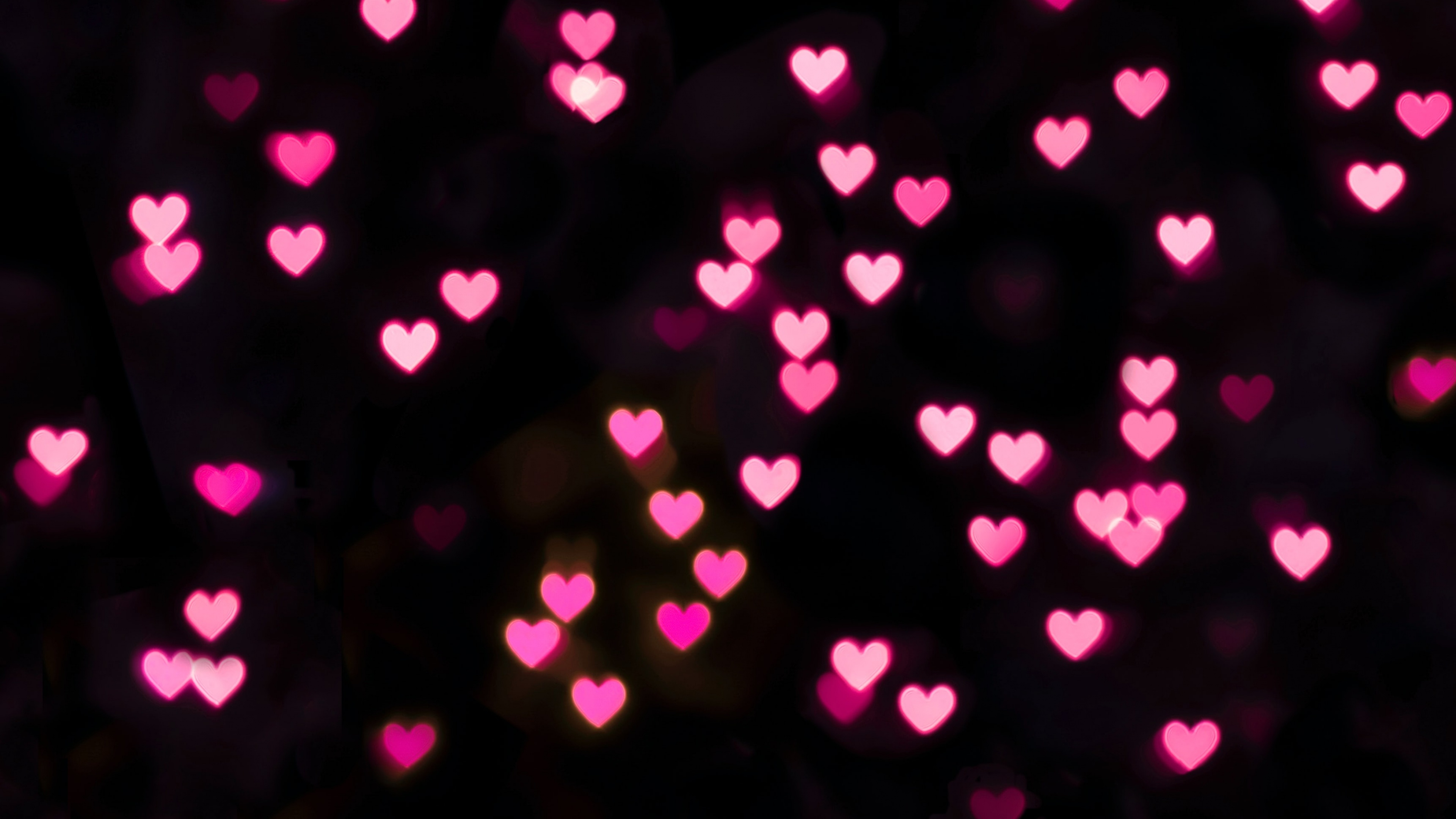 Pink hearts bokeh on a black background - Black heart