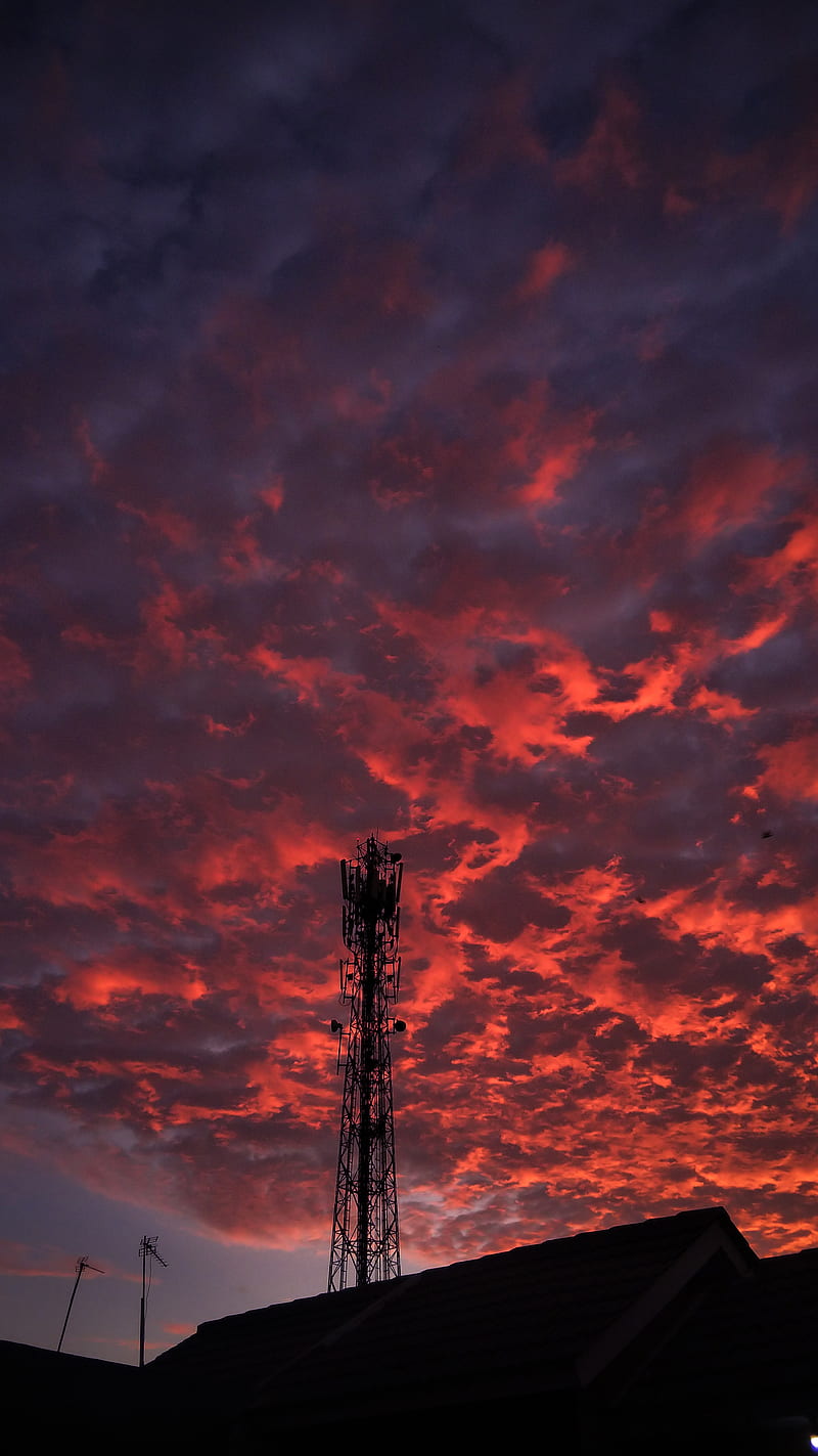 A cell tower stands tall in the sky - Sky