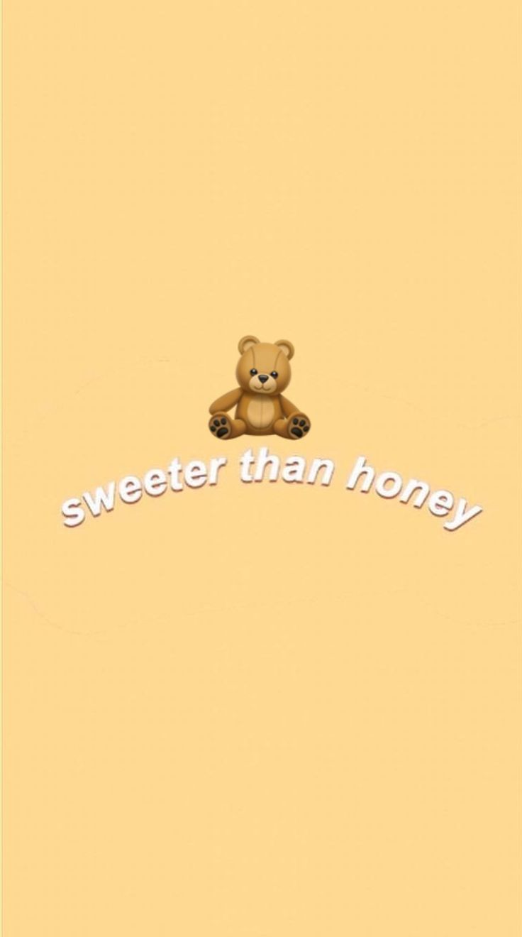 A brown teddy bear sitting on top of the word sweeter than honey - Teddy bear