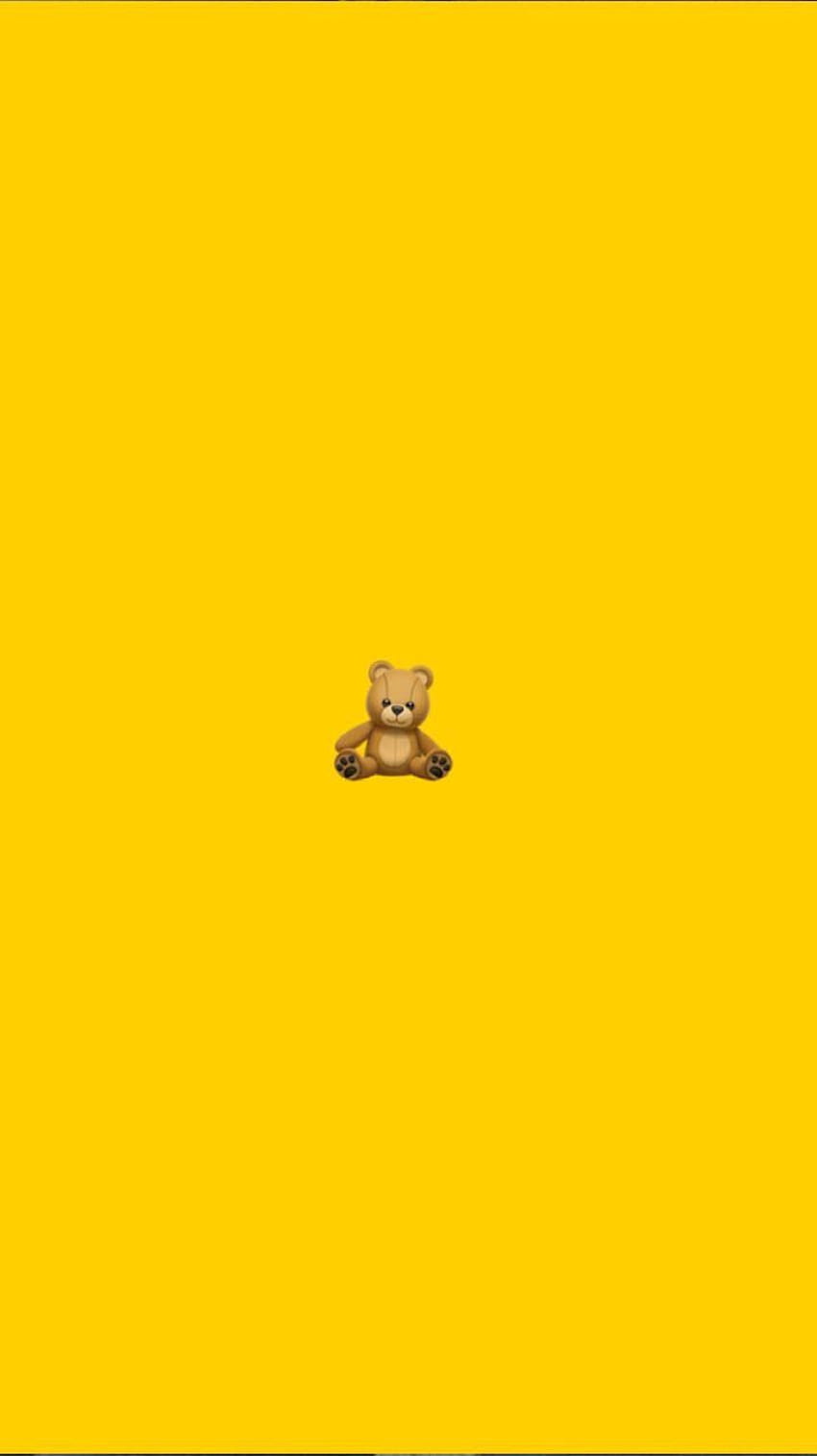 A small teddy bear on a yellow background - Teddy bear