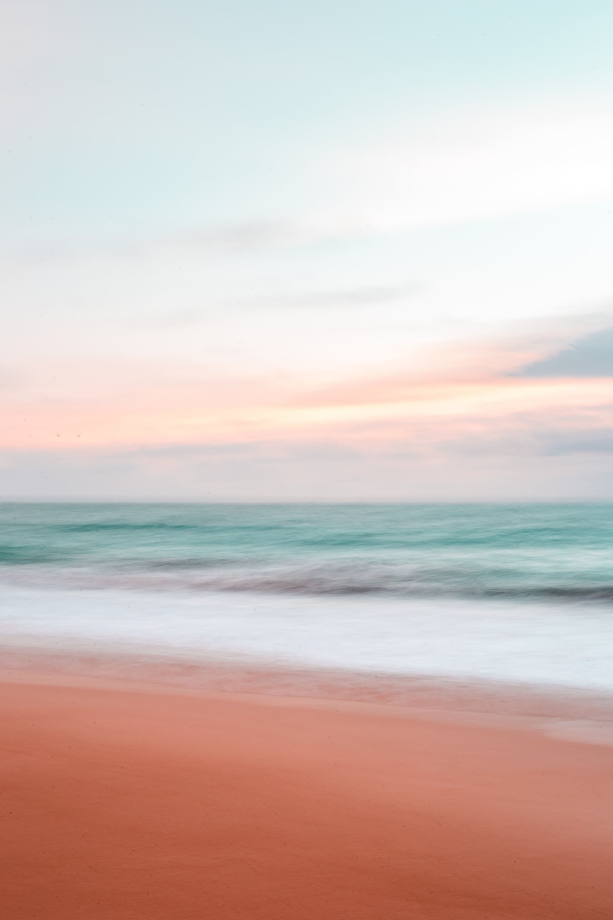 A photo of a beach with a pastel sky - Beach, water, wave