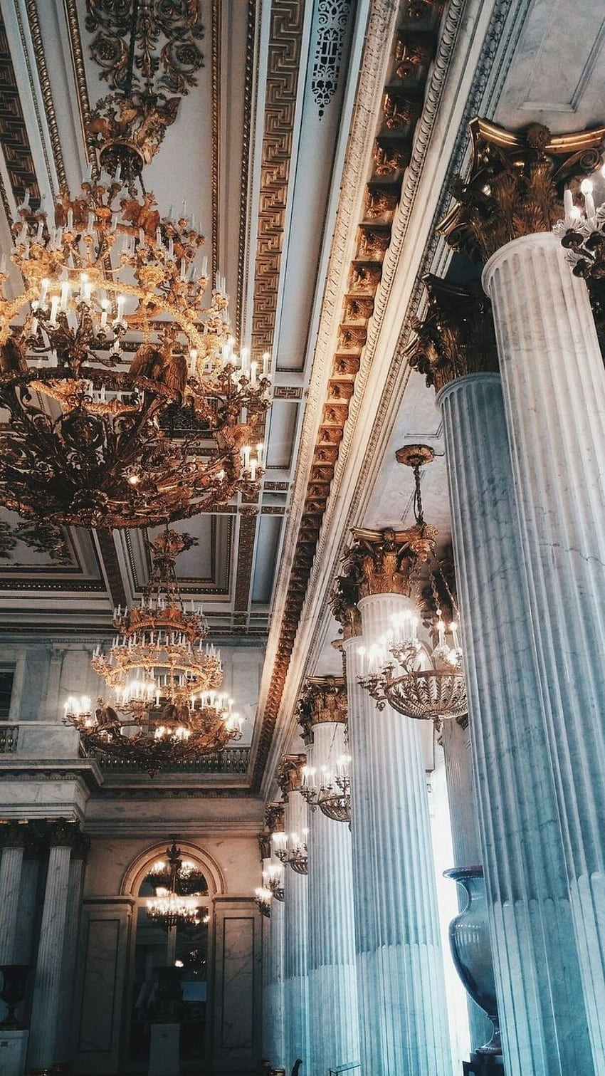 The ceiling is decorated with ornate gold chandeliers. - Architecture