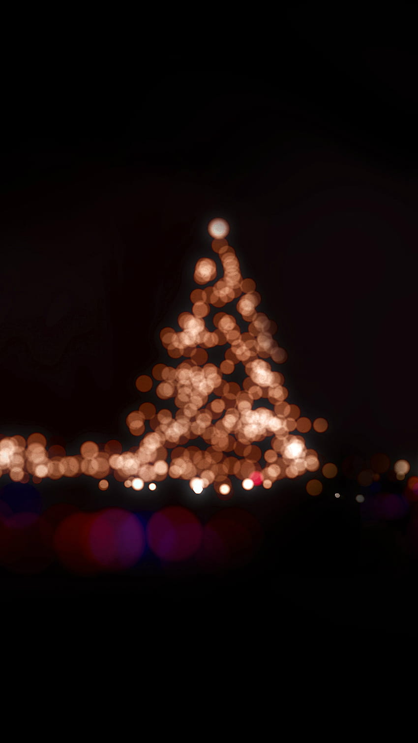 A blurry Christmas tree is lit up at night. - Christmas, Christmas lights