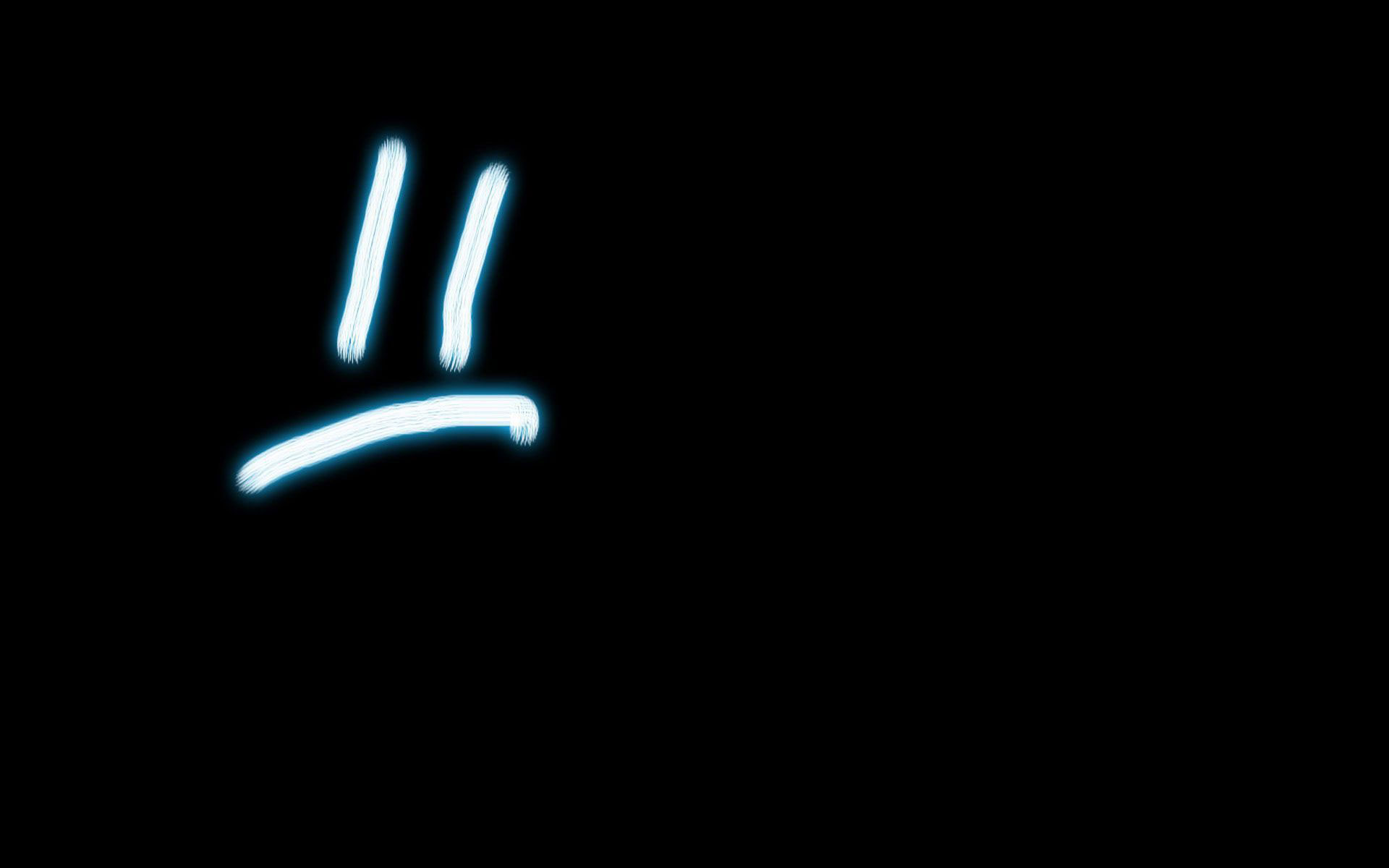 A sad face drawn in blue light on a black background - Sad
