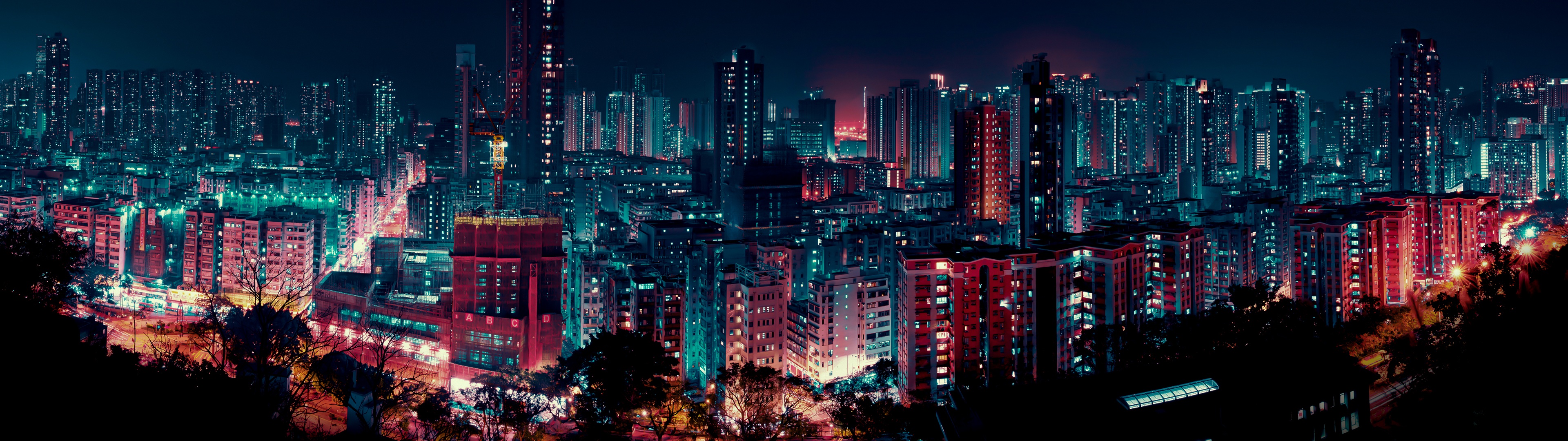 A city at night with many tall buildings - City