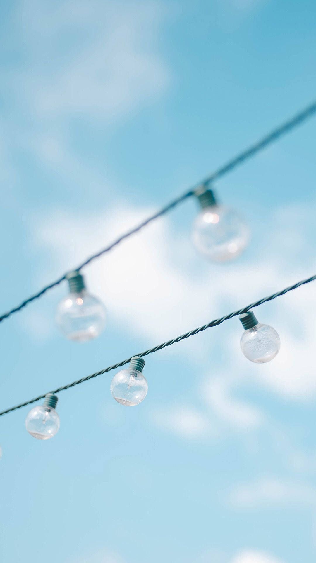 A string of lights hanging from the sky - Blue, light blue, pastel blue