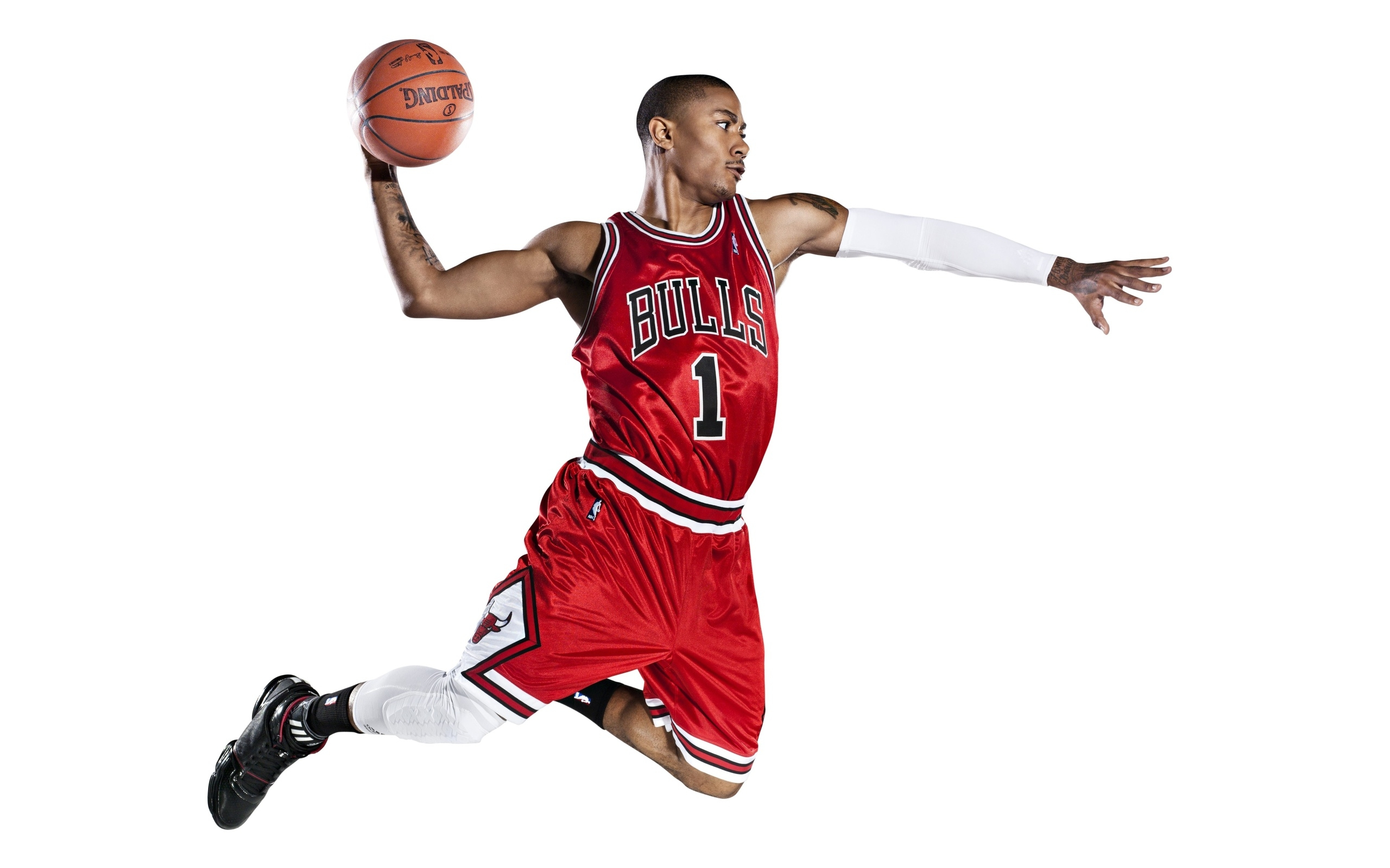 A basketball player in a red jersey jumping in the air with a basketball in one hand. - NBA