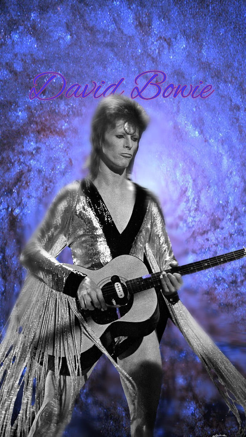 David Bowie in a silver costume holding a guitar - David Bowie