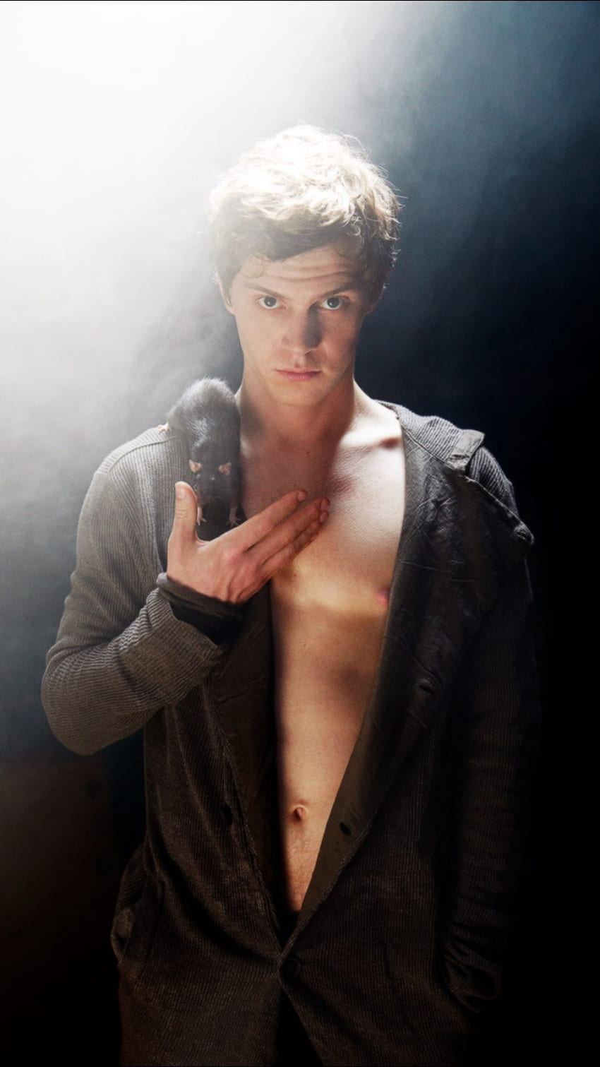 A man holding an object with no shirt on - Evan Peters