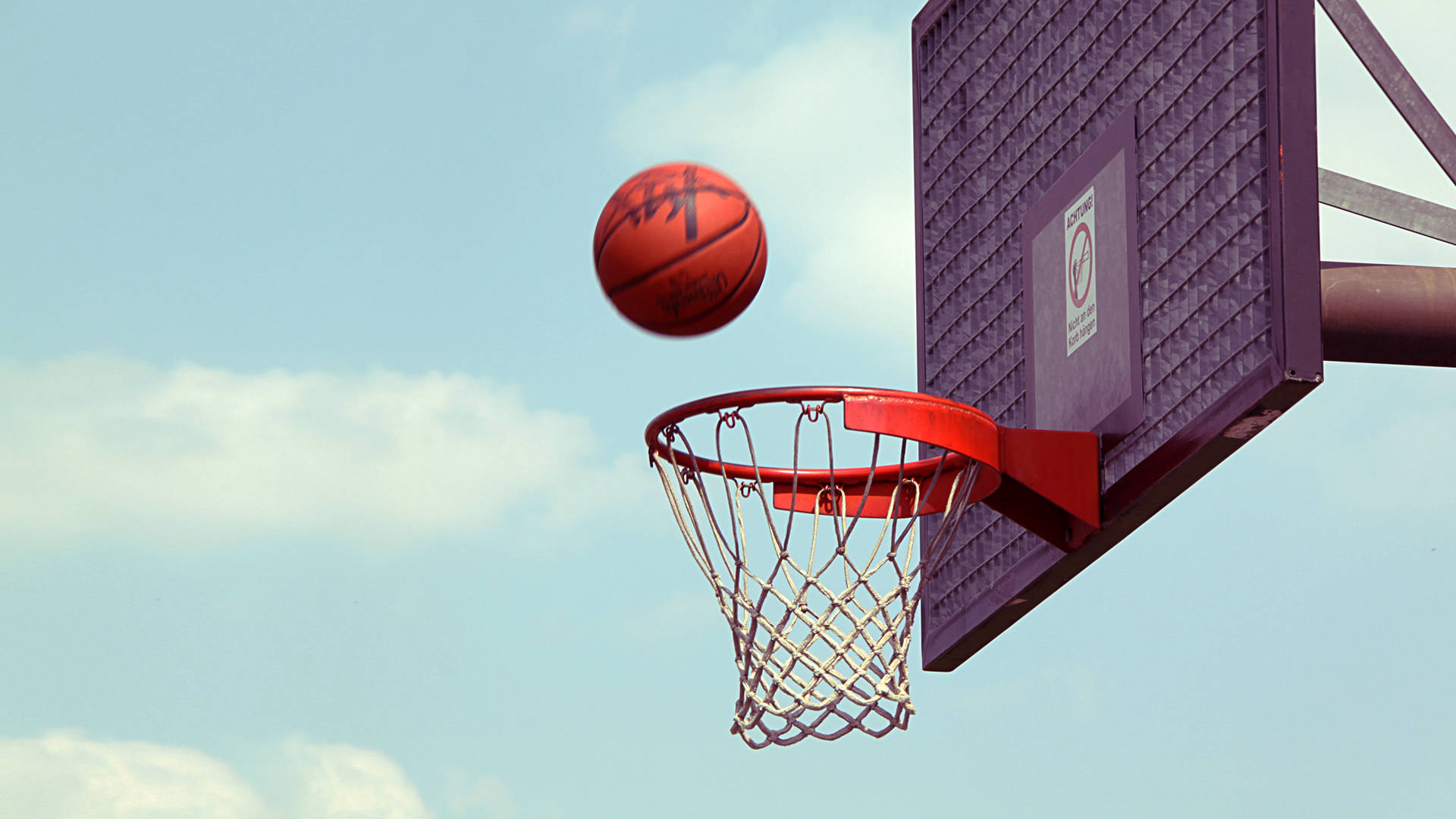 A basketball is going through the hoop - Basketball