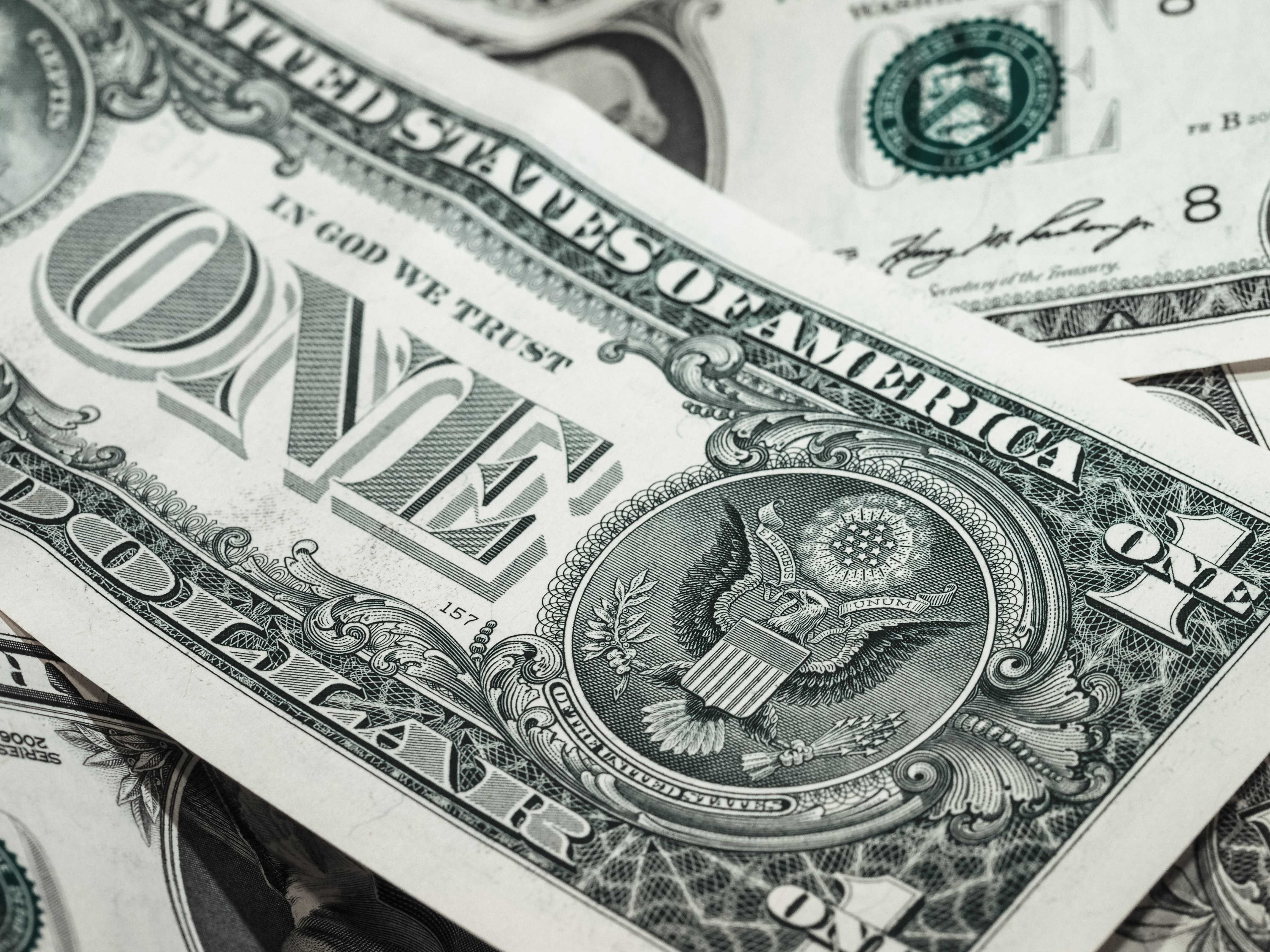 A close up of a one dollar bill. - Money