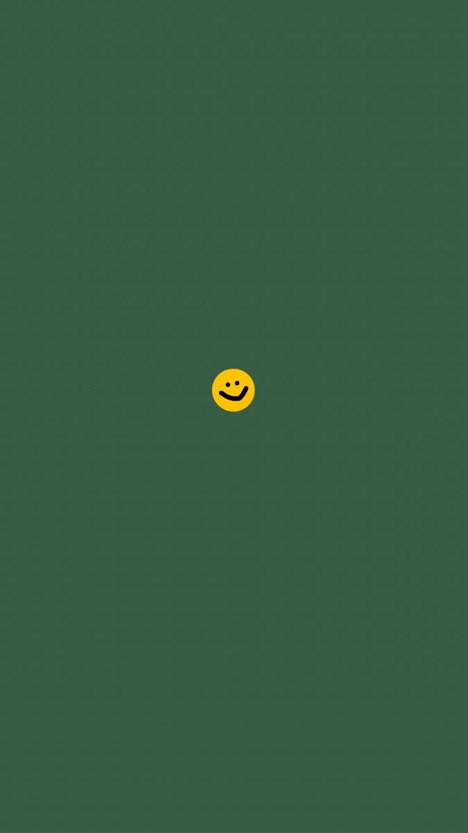 A yellow smiley face on top of green background - Colorful