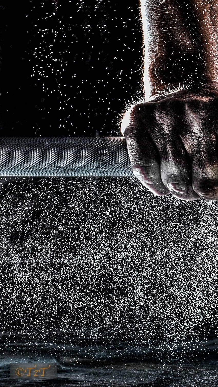A man's hand on a barbell, with water droplets falling from above - Gym