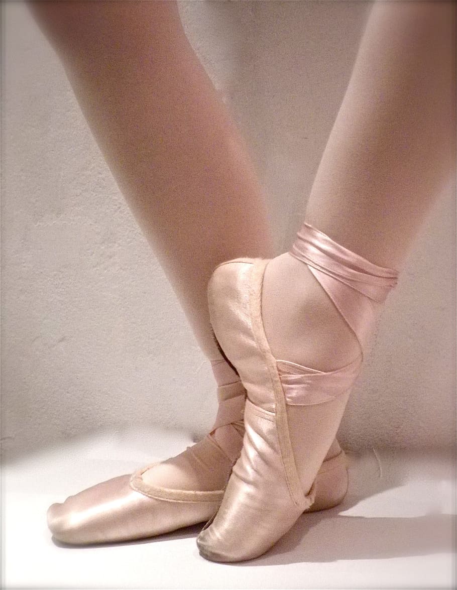 A pair of feet in pointe shoes, the shoes are a pale pink. - Dance, ballet