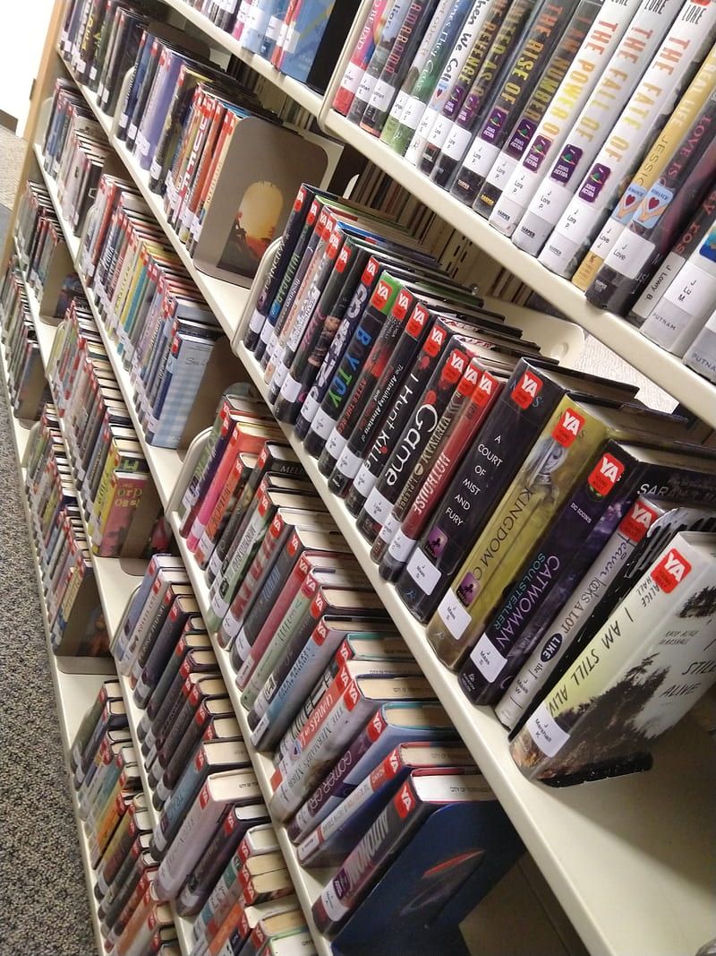 A library shelf with many books on it - Library