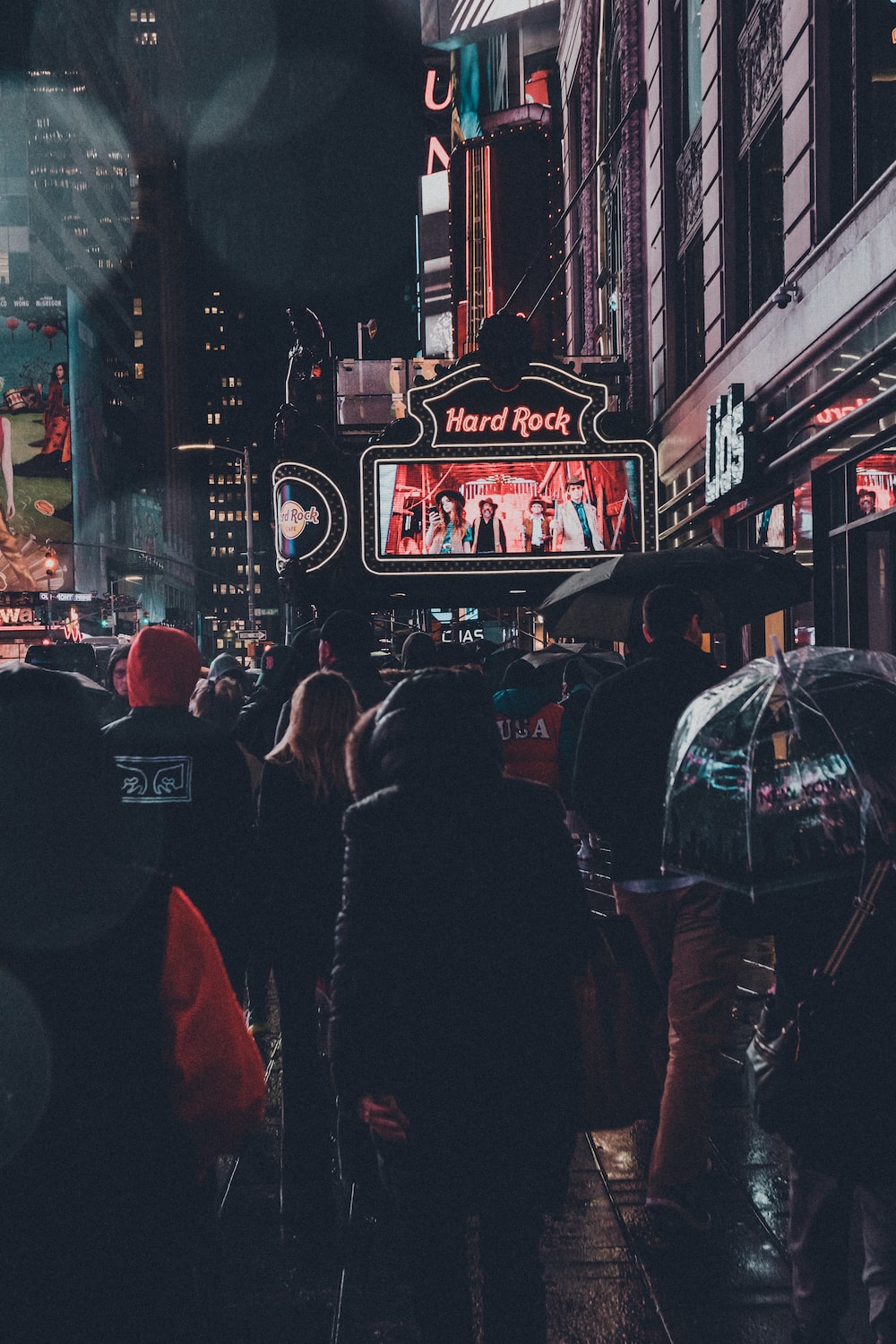 people walking on street during nighttime photo