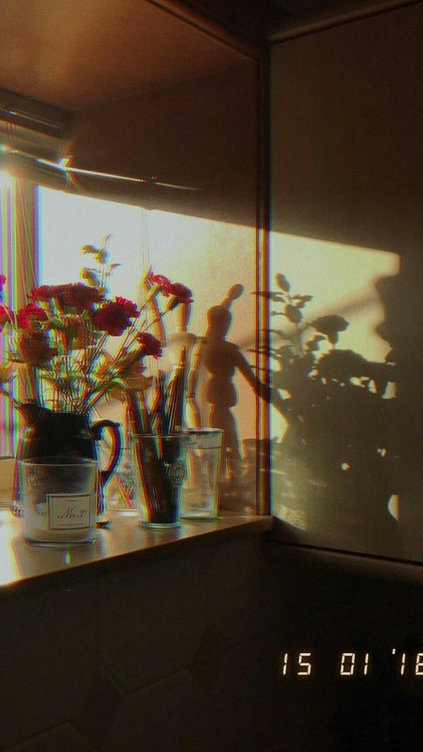A table with a vase of flowers and a wooden doll. - Sunshine, sunlight