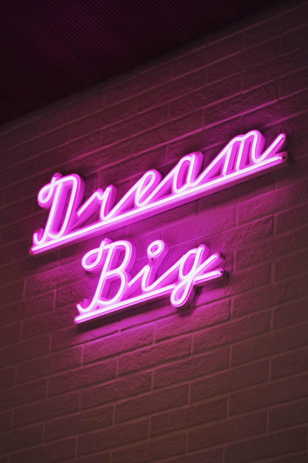 A neon sign that says dream big - Neon, alien