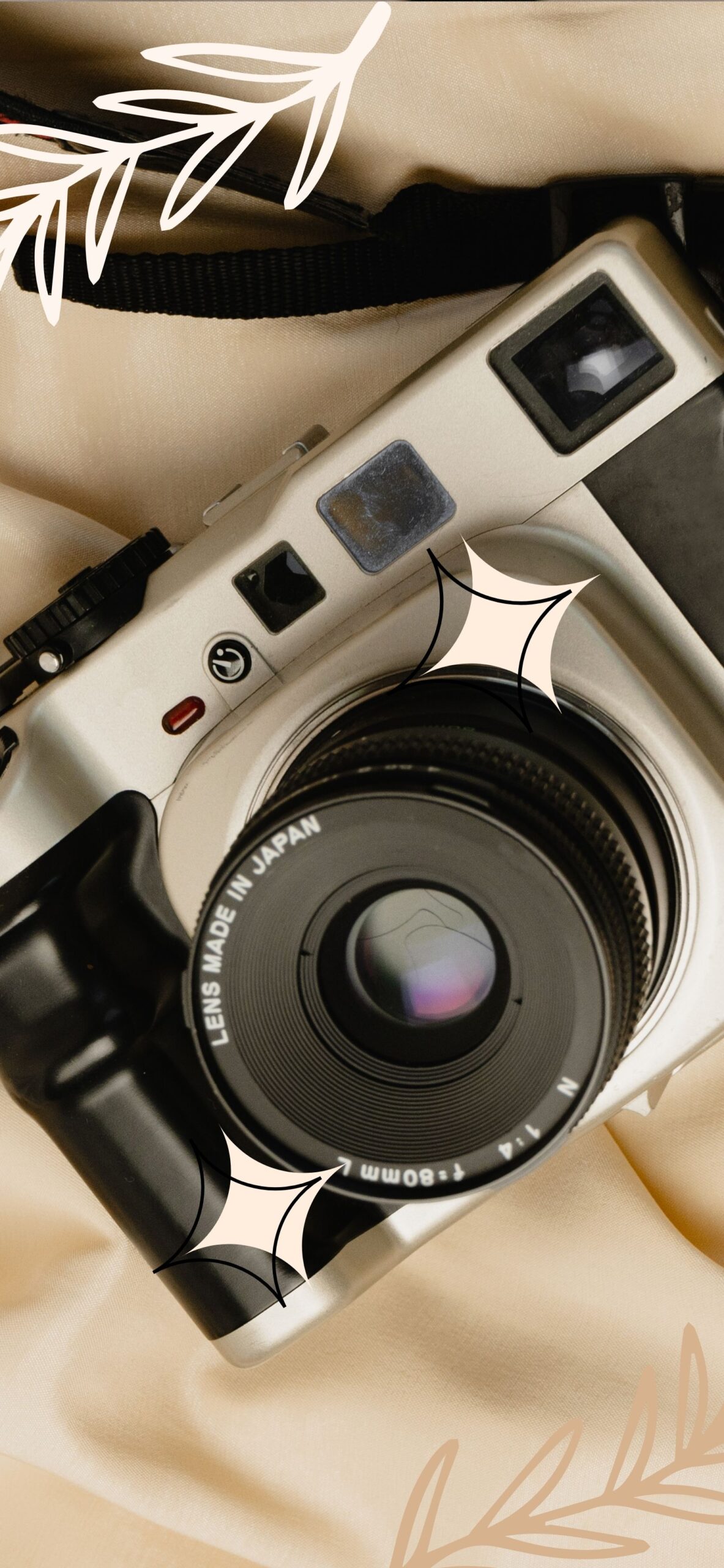 A camera with a lens and a strap - Silver