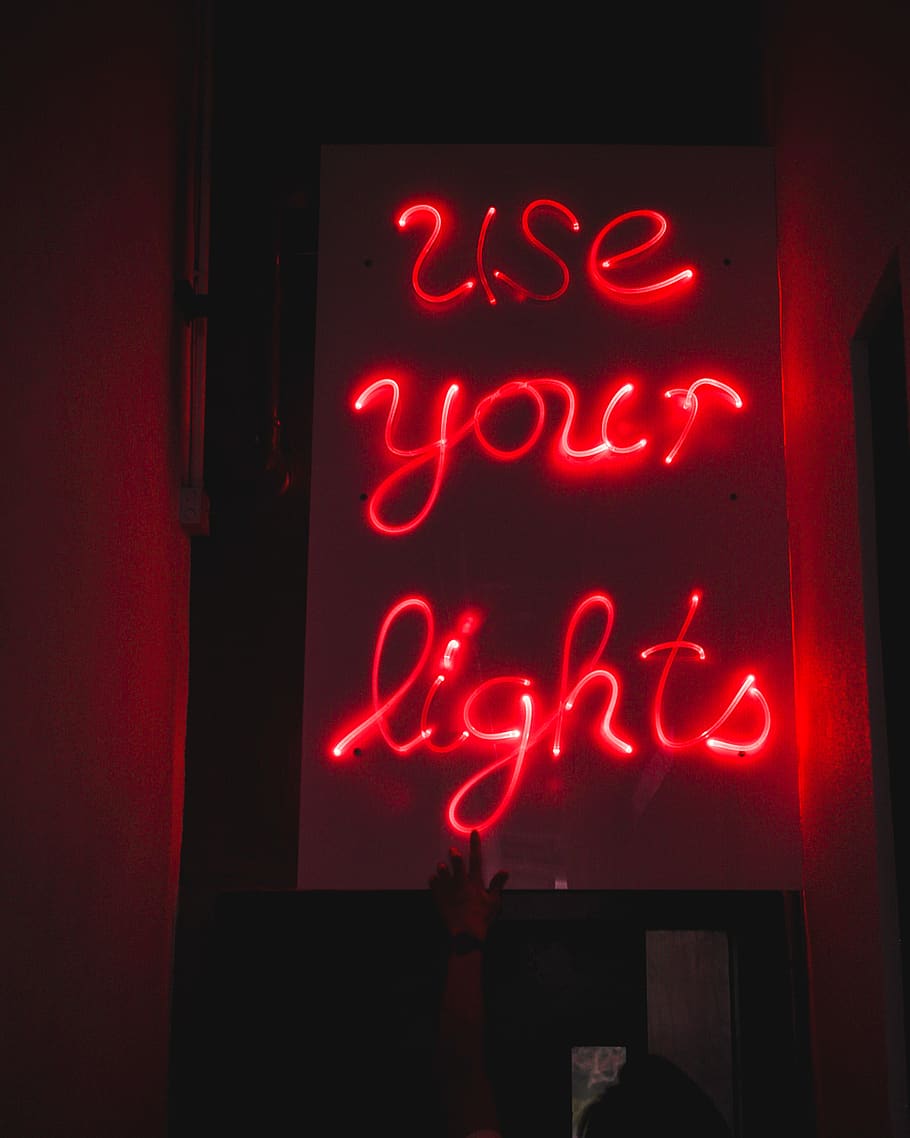 A sign that says use your lights - Light red, neon red
