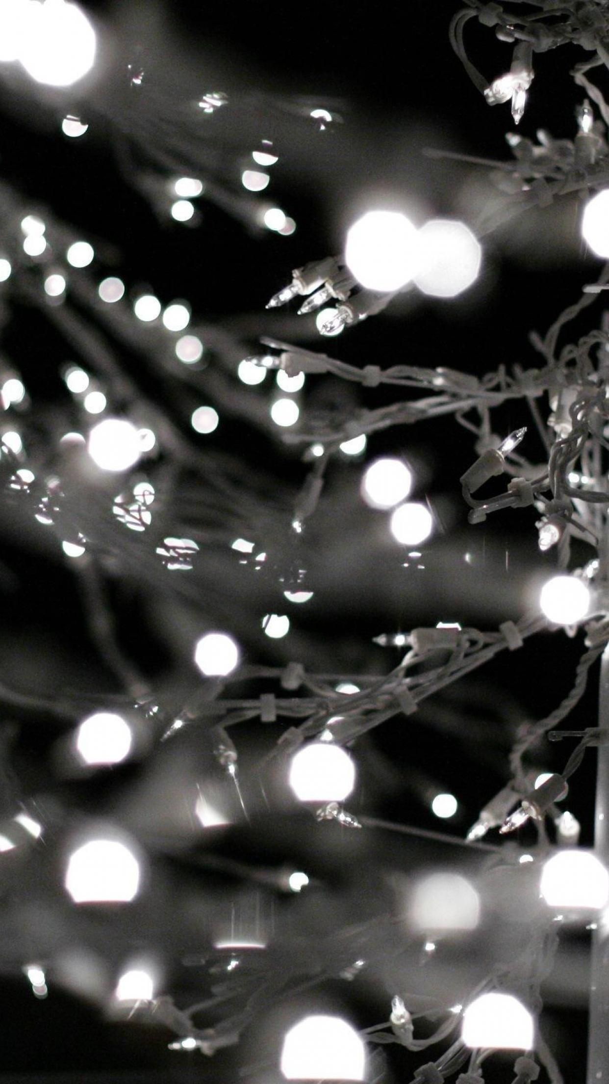 A black and white photo of a string of lights. - Christmas lights, white Christmas
