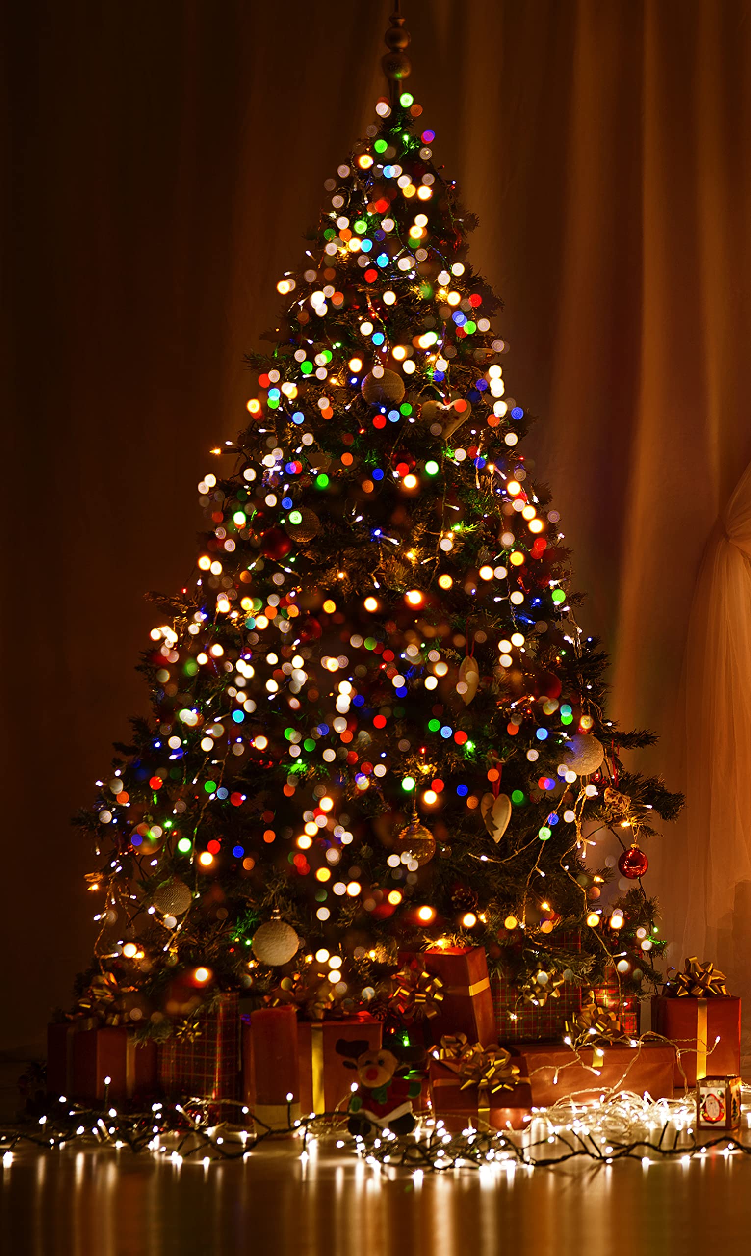 A christmas tree with lights and presents - Christmas lights