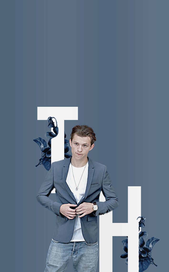 Tom Holland standing in front of a blue background - Tom Holland