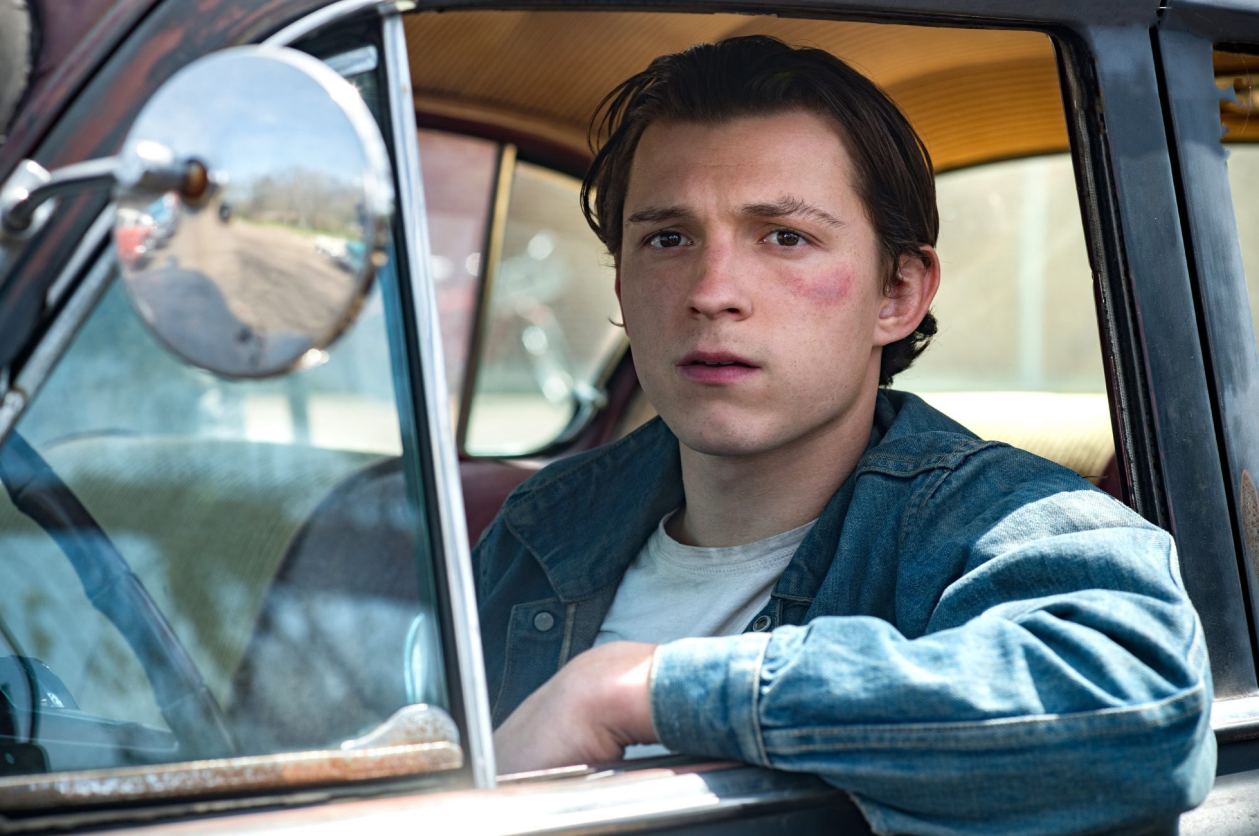 Tom Holland in a denim jacket and white t-shirt in a car - Tom Holland