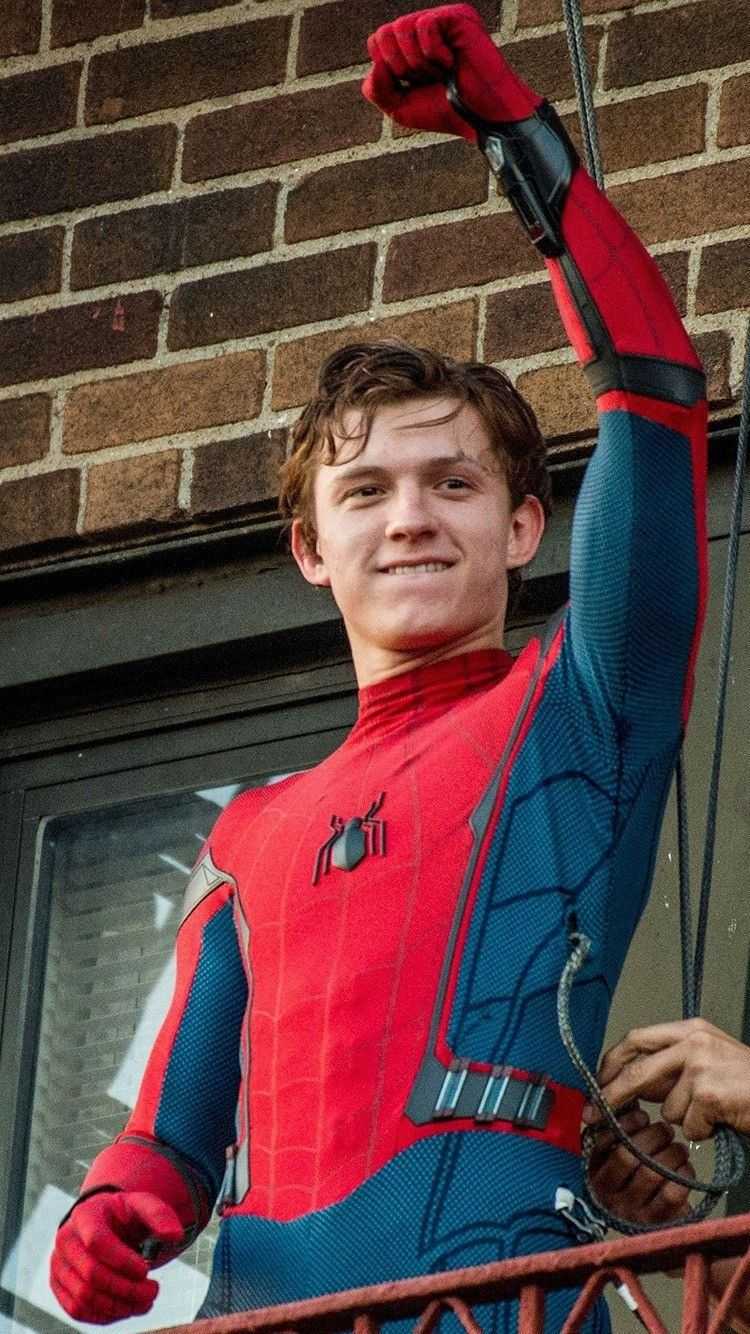 A person in spider man costume on the balcony - Tom Holland
