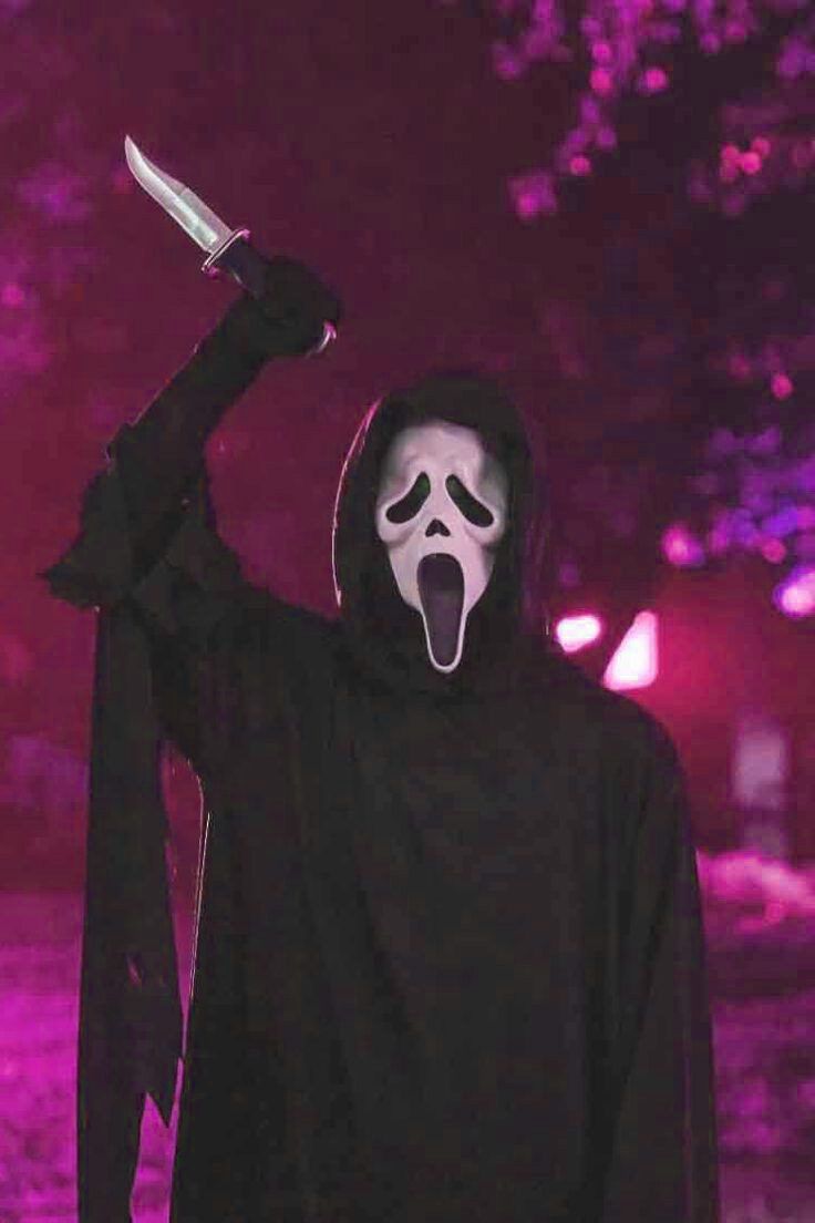 A man wearing a scream mask and holding a knife - Ghostface