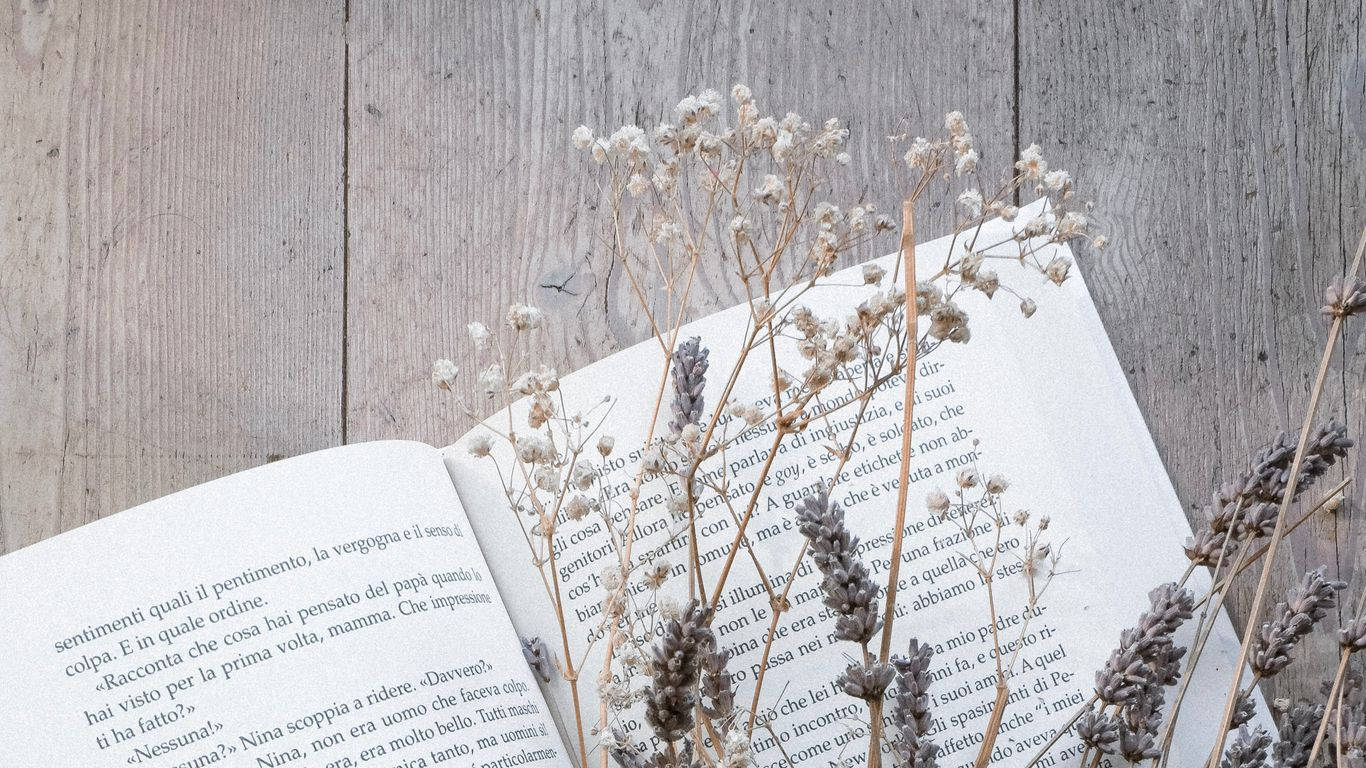 A book with dried flowers on top of it - Books