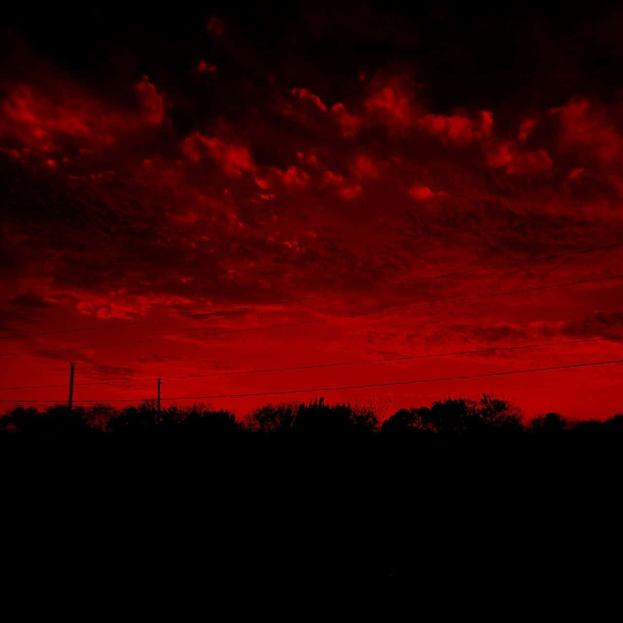 A red sky with clouds and power lines - Dark red